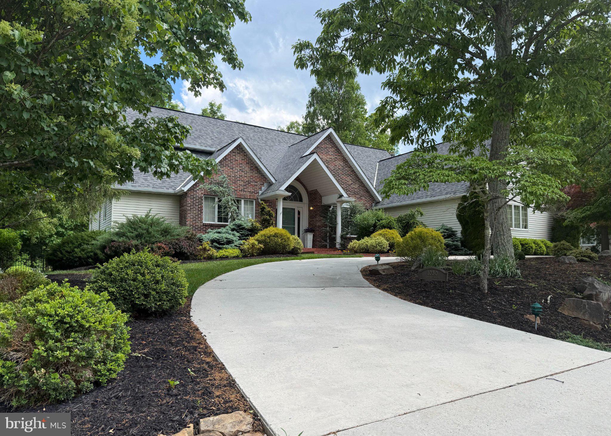 Discover a harmonious blend of luxury and comfort in this stunning contemporary residence nestled in the desirable Woodland subdivision. Spanning 3,859 square feet, this meticulously maintained home features a great room with vaulted ceilings paired with expansive glass which creates light-filled spaces merging the indoors with the outdoors, four spacious bedrooms and four elegant bathrooms including a primary entry-level en suite, ensuring ample space for relaxation. Stepping inside to find an inviting open floor plan, the heart of the home boasts a gourmet kitchen with wet bar, double oven, granite countertops, an island and a cozy breakfast area, seamlessly flowing into the family room that is perfect for gatherings. Enjoy the warmth of the fireplace or unwind in the alluring multi-purpose family room on the lower level. Outside, the beautifully landscaped .41-acre lot features a fenced back yard and charming deck, ideal for al fresco dining or morning coffee. With an attached two-car garage and thoughtful exterior lighting, this home offers both convenience and style. Experience the exclusive lifestyle this property provides, where luxury meets everyday living.