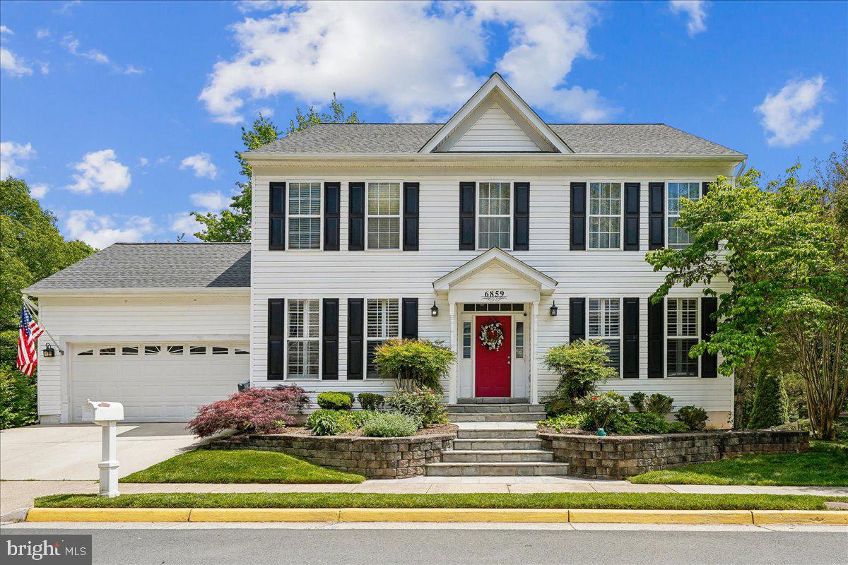 Welcome to 6859 Colonel Taylor Lane! Come see this well-maintained home, which is nestled on a peaceful no-through street. This traditional Colonial offers timeless curb appeal, architectural charm, and a spacious floor plan. A tiered stone walkway and retaining walls create a grand approach, while mature landscaping and colorful flowering gardens provide a warm and welcoming first impression. The grand entry foyer features soaring ceilings and an impressive staircase accented by custom wrought-iron railings and warm hardwood finishes. The open second-floor overlook enhances the home's spacious feel. The main level features an updated kitchen with a bright eat-in area that opens to the deck. Just steps away from your grill, making it perfect for outdoor living and entertaining. A gorgeous floor-to-ceiling stacked-stone accent wall serves as the focal point of the family room, showcasing a gas fireplace flanked by large windows that fill the space with natural light and views of the woods. This level also includes arched entryways, a formal dining room, a living room, a powder room, and a private office. Upstairs, you’ll find three spacious bedrooms and a full bathroom in addition to the primary suite. The large primary suite includes dual walk-in closets and a spa-inspired bathroom. The walkout lower-level features warm LVP flooring, a full bath, a gas fireplace, and space for entertaining, gaming, or working out. The backyard is a private oasis backing to woods, with a patio for additional outdoor living. **Recent improvements include all New Flooring (all 3 levels) in 2024, Hardwood Stairs with Wrought Iron Balusters installed in 2023, Roof (2026), and House Painted 2026** See Full List of Features & Upgrades in Listing Documents ** Ideally located near major commuter routes, shopping, dining, entertainment, and top area schools, including Bull Run Elementary and Centreville High School. Just minutes from Manassas Battlefield Park and Bull Run Regional Park, both local treasures for sledding, hiking, and exploring history. Offering the perfect blend of convenience and community living.