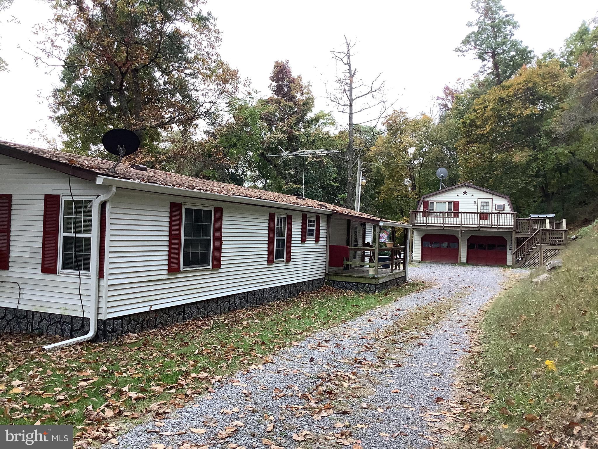 Property consists of a 3 bedroom, 1.5 Bath Double Wide with front and back deck. Situated on approx 6.51 acres. Scenic Views from the mountain looking across Martinsburg!  Property also has a detached 28
x30 2 Car detached Garage with a 2 Bedroom 1 Bath Apartment.  
This property is ready for the investor looking for rental property or a multi -family living space.