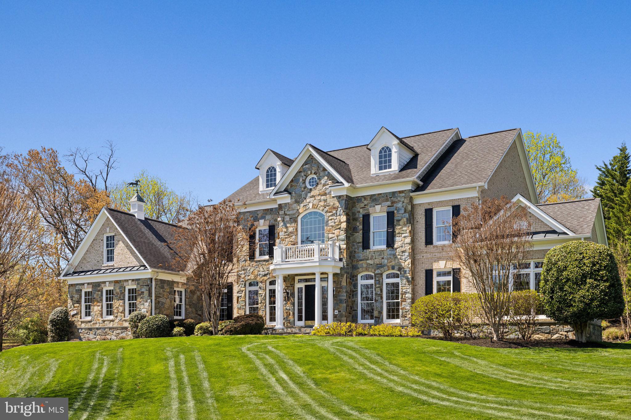 SPECTACULAR... ABSOLUTELY BREATHTAKING... RARELY does a home come along that that has been exquisitely tailored to perfection by original homeowners… Move-in ready for even the most discerning high-end buyer. Sited majestically on a 1.21 Acre cul de sac lot in the sought-after Crossings at Oakton, within easy walking distance to Flint Hill School. This exquisitely enhanced Renaissance Grand Monet has it all, including a stunning private stone terrace, gardens, a fountain and stone outdoor fireplace. Over 9,000 sf of luxury, integrating indoor and outdoor space to perfection. You are awed upon your arrival. Professional Landscaping wends along the driveway to the front garden. A bluestone walkway leads you to the elegant portico of this 4 Bedroom, 5 Full Bath, and 2 Half Bath home with 4 fireplaces! The Foyer features handsome hardwood flooring found throughout most of the main level. Everything in this lovingly manicured home has been done… from the renovated kitchen to all the bathrooms and powder rooms. Every light fixture selected with discernment. No detail overlooked. The stunning main level includes a formal Living Room and Dining Room, rich in architectural detail.  The grand formal Dining Room offers a gracious space to entertain and features stunning chandeliers and sconces.  A spectacular Sunroom is adjacent to the Living Room and is ideal for curling up with a glass of wine and a good novel. The dramatic two-story Great Room with soaring windows and floor-to-ceiling stone Gas Fireplace is completed by built-in speakers (throughout the house). It opens to the Kitchen through a Butler's Pantry outfitted with lighted display cabinetry and a wine refrigerator. The colossal Kitchen is detailed to perfection, with hardwood flooring, white soft-close cabinetry, quartz countertops, stunning marble backsplash and an enormous island with seating for 4-6 people. Appliances include Stainless Steel 6-Burner Gas Range with griddle, range hood, 2 dishwashers, door-in-door refrigerator, and under-counter microwave. A large pass-through seamlessly integrates the Kitchen with the Conservatory. A Breakfast Bar offers an ideal spot for Sunday brunch and is awash with light from 3 walls of windows. Discreetly located off the Great Room, a handsome Study overlooks the backyard and terrace. One (of two) stylishly renovated Powder Rooms is located off the gallery nook. Another family powder room is located upon entrance from the 3-car garage. The Upper-Level hallway is accessible from the grand foyer staircase and from the family staircase in the Great Room. It overlooks both the entrance foyer and the great room. The Owner's Retreat is enormous and features a generous Bedroom with deep tray ceiling, a Sitting Room with Gas Fireplace, and an elegant, renovated Bath… as well as a dressing area and 2 walk-in closets with California Closet Systems.  The Primary Bath has a free-standing soaking tub, dual vanities, a large walk-in shower with Carrera marble and multiple sprays, and a private water closet. Three auxiliary bedrooms each enjoy a private renovated bath and plenty of closet space. The Lower Level features a Family Room with Stone Gas Fireplace, a Recreation area, Game area, Guest Room/Den, Full Bath and a Playroom. Highlighting this level is an impressive Wet Bar with quartz counters and plenty of seating, and beverage fridge. A Guest Room/Den and renovated Full Bath is perfect for guests. The separate Playroom is ideal for keeping all the kids' toys at bay. Outdoors, you’ll find lush landscaping, a spectacular stone terrace with a formal garden, a stone fireplace and a fountain …providing ambiance all day and into the evening. Adjacent land around the cul de sac cannot be built on, providing complete privacy. Walk across the street to the elite Flint Hill School. Mins to I-66, Tysons, downtown Oakton & Vienna. This is the home you've earned. ... You work hard.  Isn't it time to enjoy your life?