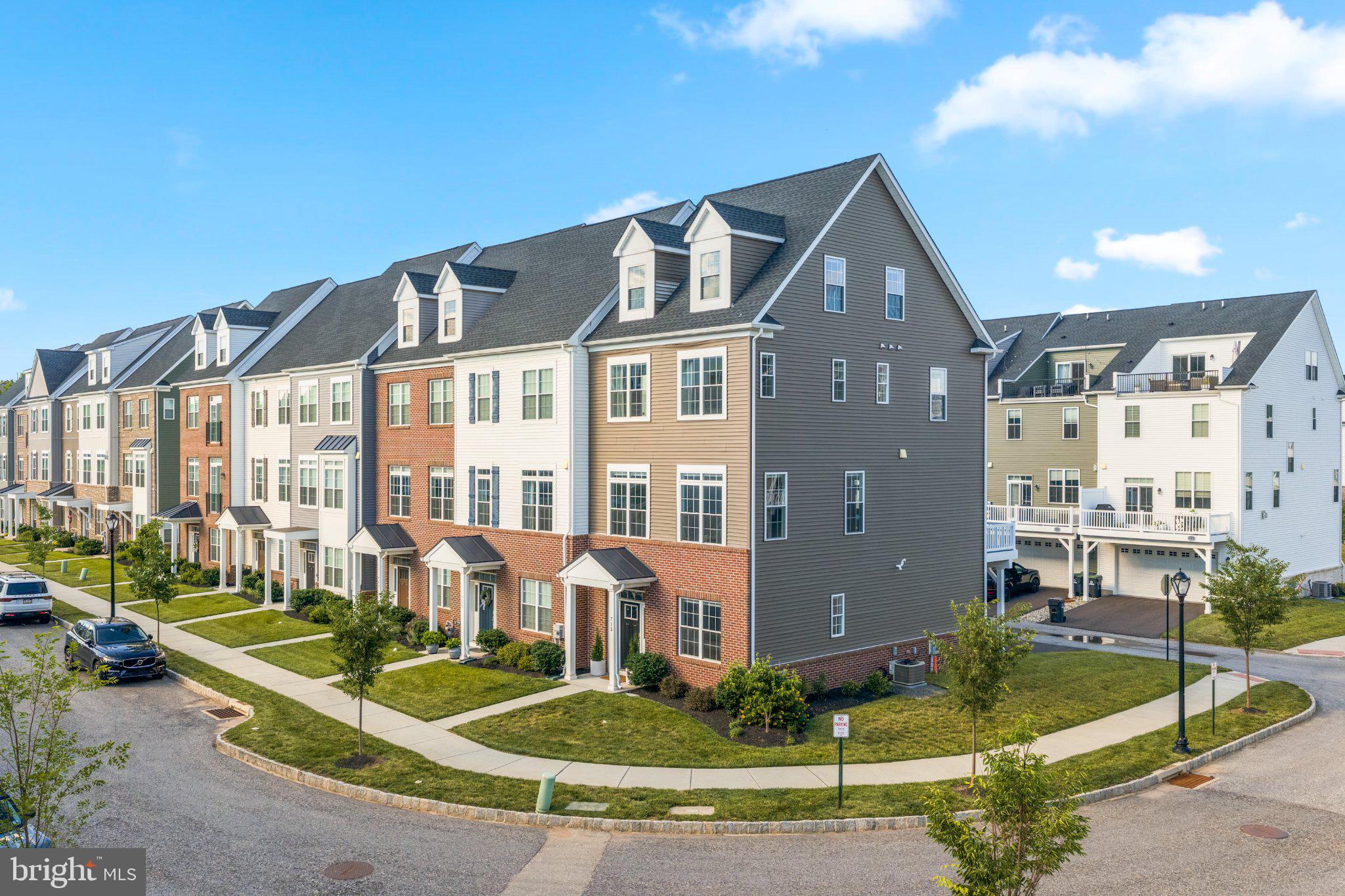 Welcome to your suburban oasis! This remarkable 4-level end-unit townhouse offers the absolute best location within Phoenixville’s highly sought-after, walk-to-town Steelpointe community. Perfectly positioned with ample spacing between neighboring properties, this home delivers an unmatched blend of luxury and sweeping views to Steelpointe Park and vibrant downtown Phoenixville—including the magnificent Ferris wheel tribute sculpture—from both the main-level deck and the spectacular, expansive rooftop deck. Impeccably maintained and thoughtfully upgraded throughout, this residence boasts a sophisticated, modern design vibe with gorgeous hardwood flooring spanning all four levels and carpeting only in the two secondary bedrooms.
The main level is a showstopper with abundant natural light from the additional windows of the end unit and is anchored by a spacious family room featuring a contemporary electric fireplace set against a stunning Roman Clay accent wall, anchored by custom floating shelving and an eye-catching sputnik-style light fixture. The open-concept layout flows seamlessly into the chef's kitchen, which boasts an upgraded KitchenAid appliance package, premium Level 5 Quartz countertops, a chic tile backsplash, and upgraded pendant lights illuminating the peninsula. The powder room has also been updated with stylish sconces mounted on a mirrored accent wall. Whether hosting friends or enjoying a quiet evening, this entire level transitions effortlessly to the main deck.
On the entry level, a bright home office offers incredible versatility, complete with a rough-in for a future bathroom to easily convert the space into a fourth bedroom. Retreating upstairs, the primary suite serves as a true sanctuary, featuring custom board and batten millwork, updated overhead lighting, and a sprawling walk-in closet with premium custom built-ins. The upgraded primary bathroom feels like a luxury spa with its double overhead shower heads, enhanced in-shower lighting, and sleek glass shower doors. Even the laundry room has been elevated with stylish custom doors.
Crown the experience on the fourth-level loft, a massive, flexible space ideal for a media hub, gym, or the ultimate home office. Bathed in light from two dormer windows, southern exposure windows as well as sliders to the roof deck. Experience the very best of Phoenixville living where you can leave your car at home and walk to the bustling downtown district, bursting with craft breweries, award-winning restaurants, boutique shopping, and community festivals. This is truly the premier unit in the community—schedule your private tour today!
