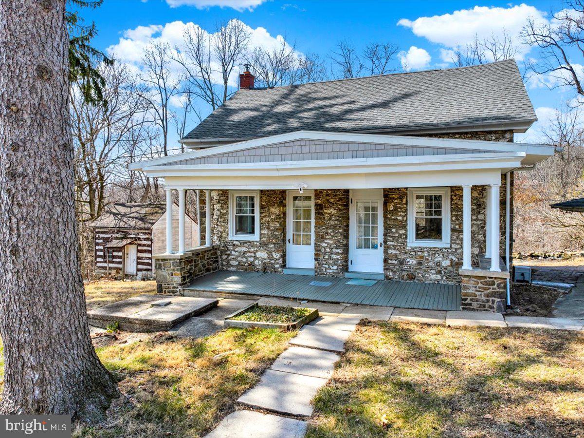 Idyllic home with the perfect blend of original beauty and modern comfort. This grey stone home has been renovated from top to bottom with painstaking care and thought, to maintain its original integrity. This homestead began with a log cabin that remains on the property to this day.  Adding to the charm is the summer house/smoke house, which sits next to the main home.  Once inside the home, you’ll appreciate the Ikea kitchen which offers an abundance of counterspace and has a modern classic color scheme, blending in perfectly the new with the old. The original hardwood floors with inlaid boarders in the dining room and living room, and the original pine plank floors upstairs have been lovingly brought back to their original beauty.  The deep windowsills throughout the house remind you of the age of this home.  All windows have been replaced, as has the roof on the main house and the garage.  Upstairs are 2 large bedrooms and a generous sized closet and large open landing.  The space exists to reconfigure this to 3 bedrooms.  The bathroom has been gutted and remodeled.  Included in the whole house remodel, the owner shored up the foundation, installed new electric with a 50 amp generator tie in, new plumbing and water treatment system to include UV filtering and softening, insulation in basement and attic, new sewer cap, new and extended heating oil storage and delivery, new Wi-Fi security lighting, new automatic garage doors, resurfaced and extended driveway and installed a new stainless steel chimney liner.  This property boasts 2 more outbuildings including a storage barn and a workshop, and all outbuildings are awaiting a  new owner to bring them back to their former glory.  There's a spring house down the stone path hill behind the house and legend has it there is even an old bomb shelter and a civil war era old cistern on this property. This property sits 1.1 miles from Rt 183 and only 2 miles from Rt 222.  This property has so much to offer, check it out soon!