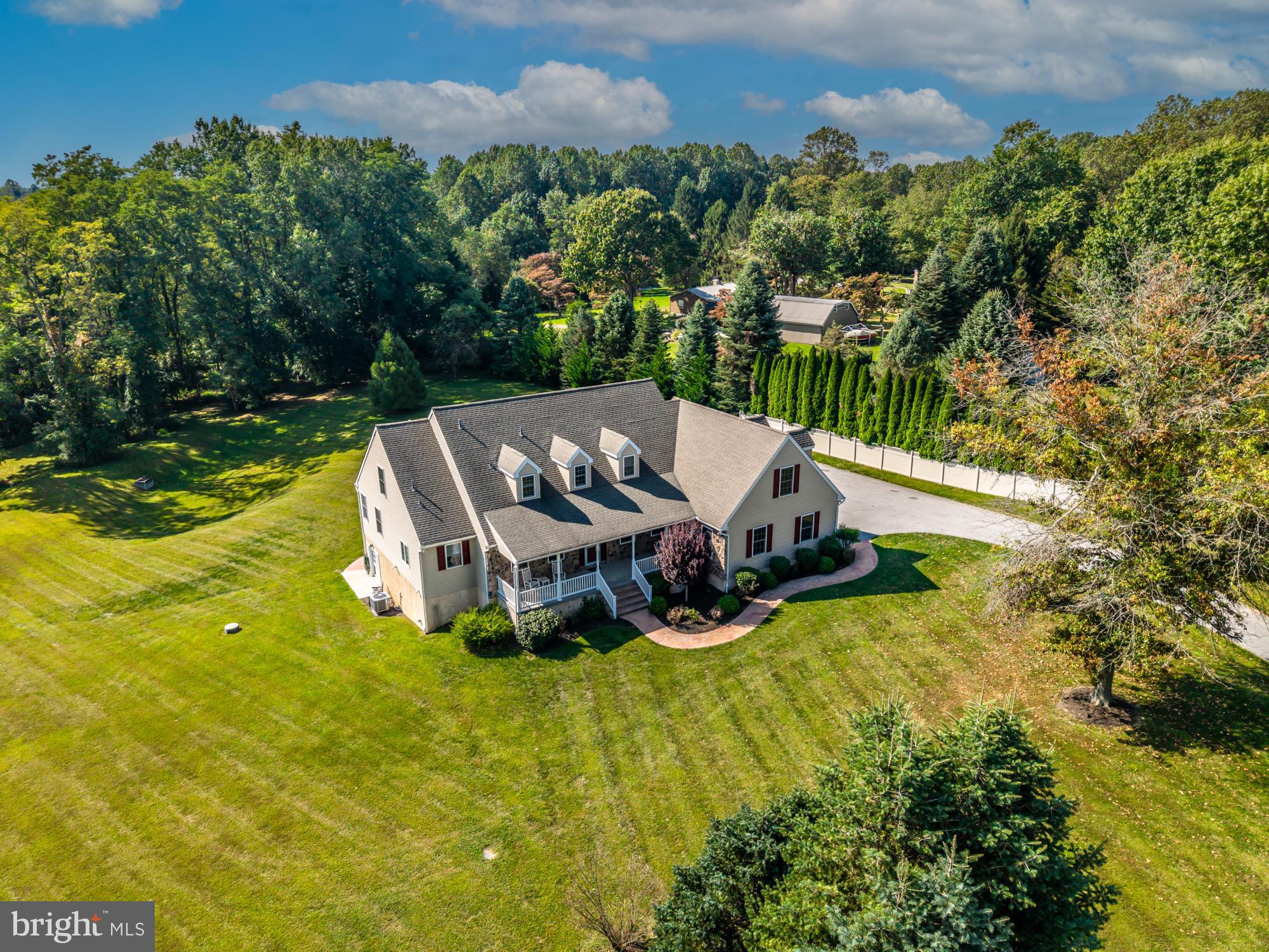 Welcome to 1657 S. Glenside Road — a spectacular 4.16-acre estate offering a rare blend of land, privacy, character, and extraordinary living spaces. If you’ve been searching for a property with acreage, a beautiful home, and an 1800s bank barn fully restored for modern use, your search ends here.
The bank barn is a showpiece: metal roof, 2–3 bay garage/workshop, and an upper level with incredible storage plus finished square footage — perfect for a studio, hobbyist space, or future conversion.
Step inside the home and you’re welcomed by a charming covered front porch with ceiling fans and timeless curb appeal. The two-story foyer opens to a semi-formal dining room on one side and a main-level bedroom or office with an attached full bath on the other.
The heart of the home is the dramatic two-story family room, filled with natural light and featuring a fireplace and French doors to the expansive decking, above-ground pool, and peaceful outdoor views. The open kitchen offers abundant space, sliders to the deck, and a cozy adjoining sunroom you’ll love year-round. A laundry room and mudroom connect the side door and the oversized attached two-car garage.
The main-level primary suite provides convenience and comfort with a full en-suite bath, walk-in closets, and sun-soaked windows.
Upstairs, a spacious loft provides flexibility for a gym, playroom, office, or lounge. You’ll also find two generous bedrooms, a full hall bath, and an almost-finished bonus room with electric, HVAC, already in place — perfect for a future home theater or creative space.
A full walkout basement, already plumbed for a bathroom, offers endless possibilities for expansion.
This remarkable property truly has it all — land, charm, a stunning barn, flexible spaces, and a layout designed for both comfort and entertaining. Opportunities like this are rare. Schedule your appointment today!