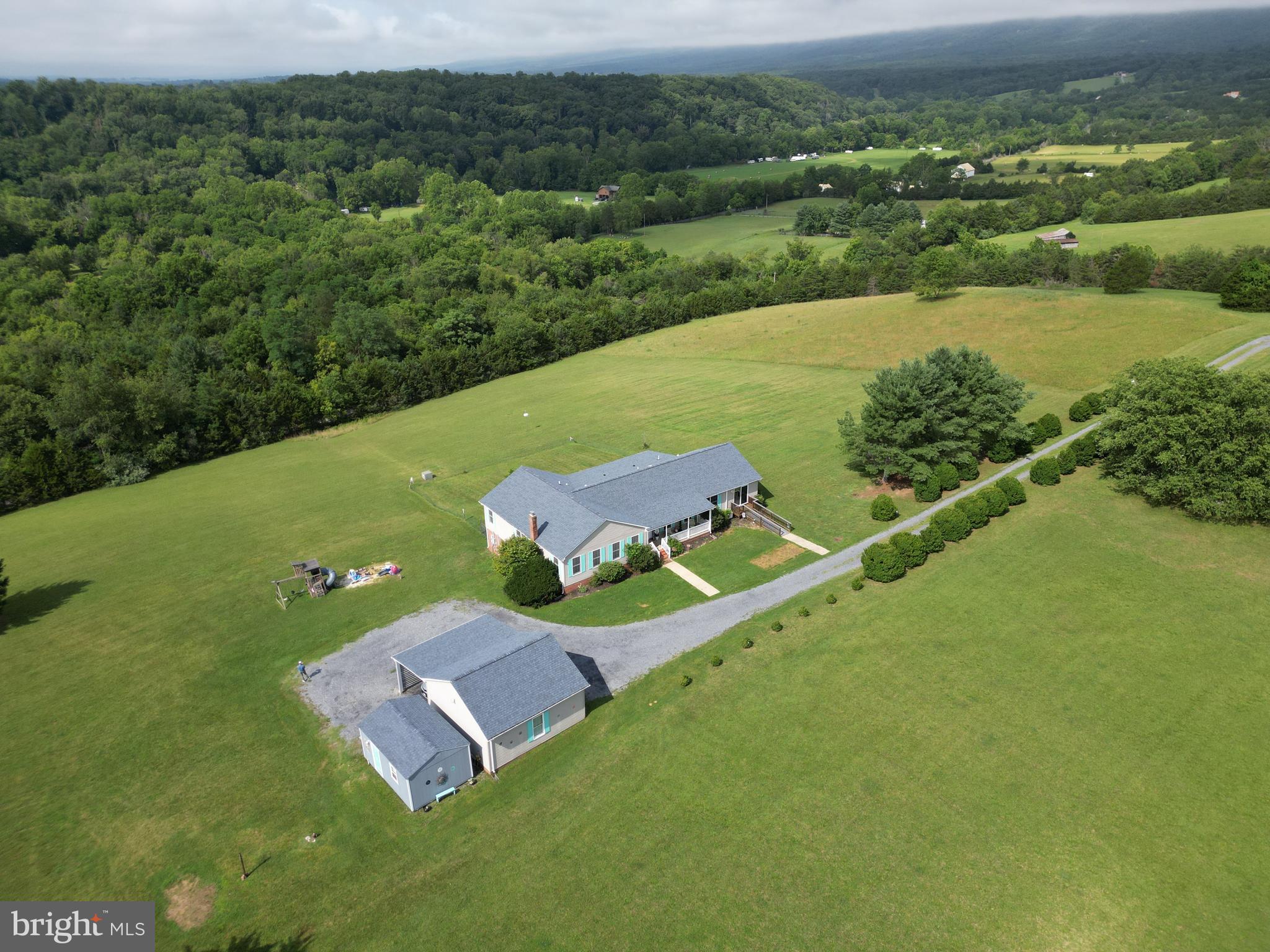 Looking for a forever home that is MOVE-IN READY and has breathtaking MOUNTAIN VIEWS?! 217 Silver Bell Ln is located on over 6 private acres, with over 3,500 finished sq ft and RIVER ACCESS. These owners poured their hearts into renovating their home, with almost 300K in UPDATES. Sit on the new SCREENED IN PORCH with recessed lighting, repainted flooring, and overhead fans, and drink your morning coffee with mountain views, and even hear the river in the winter. 
<br><br>
The main level of this home offers 4 bedrooms, updated bathrooms, recessed lighting, a main-level laundry, and two large living rooms (27’ x 13’ and 26’ x 14’) and LVP flooring throughout. This home features an upgraded kitchen with quartz countertops, barstool seating, and an island. The large 16’ x 15’ primary bedroom includes a double closet and an updated bath with a soaking tub, tile shower, waterfall showerhead, and touchscreen mirror. The primary bedroom also has an added door leading out to the screened-in porch, serving as a private entrance. 
<br><br>
The finished lower level offers incredible flexibility. In addition to a fifth bedroom with an attached half bath and new luxury vinyl plank flooring, there's plumbing already in place nearby, offering potential for a future wet bar or kitchenette—making this level ideal for guests or multi-generational living. Four additional enclosed rooms, including one with a walk-in closet, provide endless possibilities for home offices, hobby rooms, guest rooms, workout space, or storage. A large 24' x 18' recreation room with French doors opens to the covered patio, complete with a metal roof and retaining wall, creating another wonderful outdoor living space to enjoy the mountain views.

<br><br>
Although you'll feel tucked away in your own private retreat, you'll still enjoy high-speed internet and excellent cell service. The tree-lined driveway provides a welcoming sense of privacy and plenty of parking. The detached two-car garage, additional carport, and large storage shed offer exceptional storage and workspace. Other thoughtful features include new deck steps leading to the backyard, a fenced area for pets, a welcoming front porch, and a ramp providing handicap accessibility to the second living room. 
<br><br>
Since 2020, the home has seen extensive improvements, including a new roof and nearly $300,000 in renovations, allowing the next owners to simply move in and enjoy.
<br><br>
As the sellers put it best, this truly is "a vacation home you get to live in." Come experience everything this one-of-a-kind property has to offer.