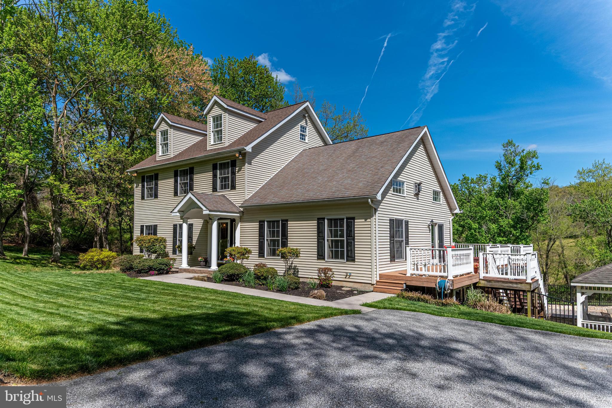 Experience the rare opportunity to own a pristine five-acre private estate located within the highly desirable Hereford Zone school district. Set back in a serene, park-like setting, this exceptional property is surrounded by mature trees and neighboring farmland, offering a true sense of privacy while remaining conveniently close to everyday amenities.  The grounds are a nature lover’s dream, featuring a freshwater stream, a stocked pond, and expansive open space ideal for recreation, relaxation, or equestrian use. Whether you enjoy fishing, peaceful walks, or simply taking in the beauty of the outdoors, this property provides a tranquil retreat with endless possibilities.  The three-story residence is thoughtfully designed with an open-concept main level highlighted by soaring 20-foot ceilings, oversized windows, a skylight, and a bay window that flood the home with natural light. Rich ¾-inch Acacia wood plank flooring runs throughout the main living space, anchored by a dramatic 20-foot stone fireplace that serves as a stunning focal point.  The kitchen is both stylish and functional, featuring stainless steel appliances, granite countertops, and an expansive island with ample seating—perfect for entertaining or everyday living. The adjacent dining area offers picturesque views of the stream-fed pond and lush grounds through a charming bay window. Two generously sized bedrooms and bathrooms are also conveniently located on the main level.  Upstairs, an open hallway with railing overlooks the main living area, enhancing the home’s airy and light-filled design. The second level hosts an impressive primary suite complete with a spa-inspired bathroom featuring a freestanding soaking tub, separate shower, and double vanity. An additional room on this level provides flexibility as a fourth bedroom, office, or guest space.  The third floor adds even more versatility, ideal as a fifth bedroom, home office, or bonus/activity room to suit your lifestyle needs.
  The walk-out lower level is designed for relaxation and entertainment, offering ample space for gatherings and recreation, including a pool table. Modern efficiency meets comfort with a dual-zone geothermal heating and cooling system, along with a continuously circulating hot water loop for near-instant hot water throughout the home.  Step outside to your own private resort-style oasis. The beautifully designed paver patio surrounds a 50-foot heated saltwater pool and a spacious cabana, creating the perfect setting for entertaining or unwinding. Additional outdoor features include a fire pit, a large tiki bar, and a hot tub seamlessly built into the elevated deck—ideal for year-round enjoyment.  Additional highlights include an oversized attached garage and a substantial 30’ x 40’ detached garage/pool house complete with its own bathroom. This versatile structure also offers a full երկրորդ floor for storage, a covered parking or wash bay area, and a separate driveway access—perfect for housing equipment, recreational vehicles, or an extensive collection of hobbies and toys.  This one-of-a-kind property offers a unique blend of privacy, luxury, and functionality—an exceptional place to call home.