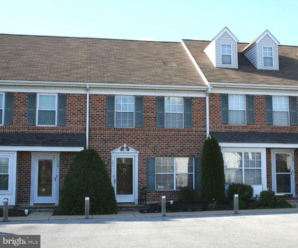 Adorable 2 BR, 1 1/2 bath condo with a nice back yard in a great location! Washer, dryer, & frig included. Lovely wood laminate floors in entry hall and kitchen. Monthly fee covers mow, mulch, snow removal, water, sewer, trash & exterior maintenance.  Community, HOA is FHA/VA approved.