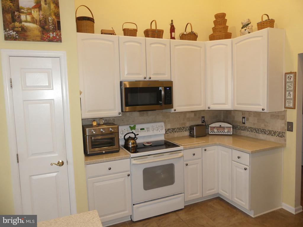 BEST VALUE IN BEL AIR! UPGRADES GALORE! TOP FLR (ELEVATOR) W/1600 SQ FT OF OPEN LIV SPACE. UPDATED GAS HVAC & WATER HEATER 2015. LUXURY VINYL PLANK FLRS IN LIV/DIN/FOYER & BEDRMS. CORIAN KIT W/42" CAB'S, C-TILE FLR, B-IN SS MICRO, SMOOTH TOP STOVE, SS FRIG W/H2O & ICE DISP, BACKSPLASH & B-BAR. BREAKFAST RM W/C-TILE FLR W/ACCESS TO BALCONY W/STORM DR. FOYER W/W-IN CLOSET. PRIM BEDRM W/SIT RM & OVERSIZED W-IN CLOSET. UPDATED BA 1 W/NEW CABINETRY, LIGHTING, C-TILE FLR, W-IN "FRAMELESS" SHOWER W/SEAT & GRAB BARS. BED 2 AT OPPOSITE END. UPDATED BA 2 W/NEW VANITY, VESSEL SINK & C-TILE FLR.  VAULTED CEIL'S W/CROWN MOLDING, NEW HUMIDIFIER ON FURNACE. WATER PURIFICATION SYSTEM. SPEAKER SYSTEM. STORAGE CLOSET IN HALL. 55+ COMM