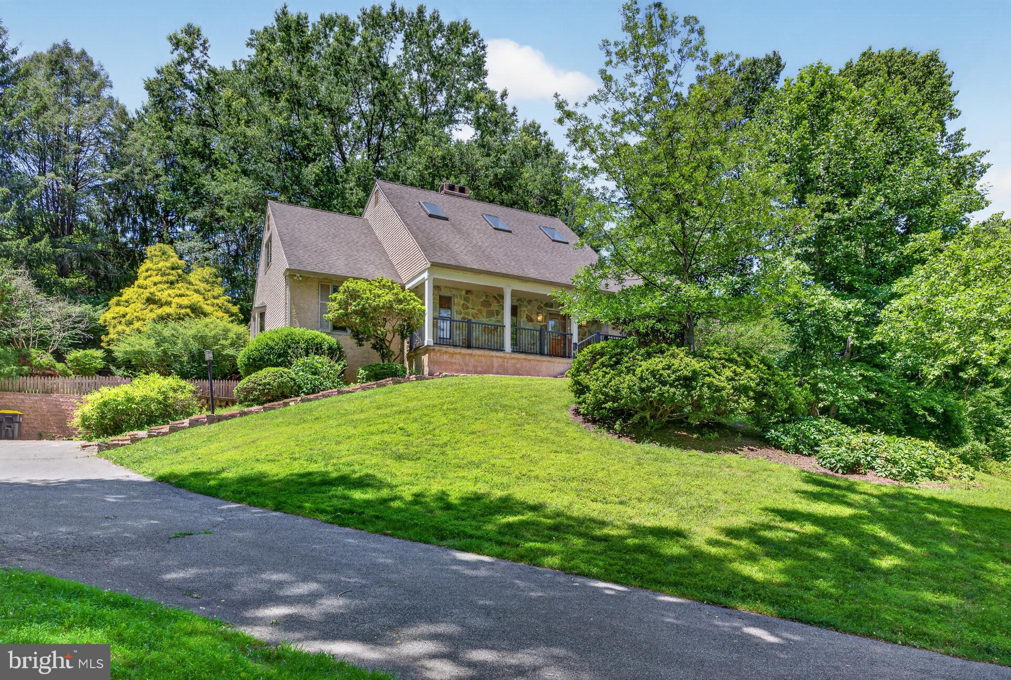 Welcome home to this stunning natural retreat, ideally located in Upper Pike Creek just minutes from parks and scenic walking trails. This spacious Cape Cod-style home offers timeless charm, exceptional living space, and a private setting that feels like a getaway every day.

Inside, a grand foyer with vaulted ceilings and beautifully refinished hardwood floors welcomes you. The inviting living room features a wood-burning double-sided fireplace, while the spacious dining room flows seamlessly into the entertainer’s kitchen, complete with a large island, wet bar, beverage refrigerator, granite countertops, and abundant cabinetry. A bright three-season room overlooks the peaceful backyard, providing the perfect place to relax and unwind.

The FIRST-FLOOR primary suite is a true retreat, offering a sitting area, dual walk-in closets, and a luxurious bath with heated floors, dual vanities, a soaking tub, and tiled shower. Upstairs, you'll find four generously sized bedrooms and a beautifully renovated full bath. The finished basement adds even more versatility with a kitchenette, full bath, and ample living space for guests or multi-generational living.

Outside, enjoy your own backyard oasis featuring a spacious deck, hot tub, retractable awning, fire pit, and serene natural surroundings. Additional highlights include geothermal heating, water treatment system (owned), Renewal by Andersen windows and sliding door (2025), fresh first-floor paint (2026), front porch railings (2025), chimney lining (2026), fresh paint in entryway, living room and primary bedroom (2026). Conveniently located near shopping, dining, and entertainment, this exceptional home offers the perfect blend of comfort, privacy, and convenience.