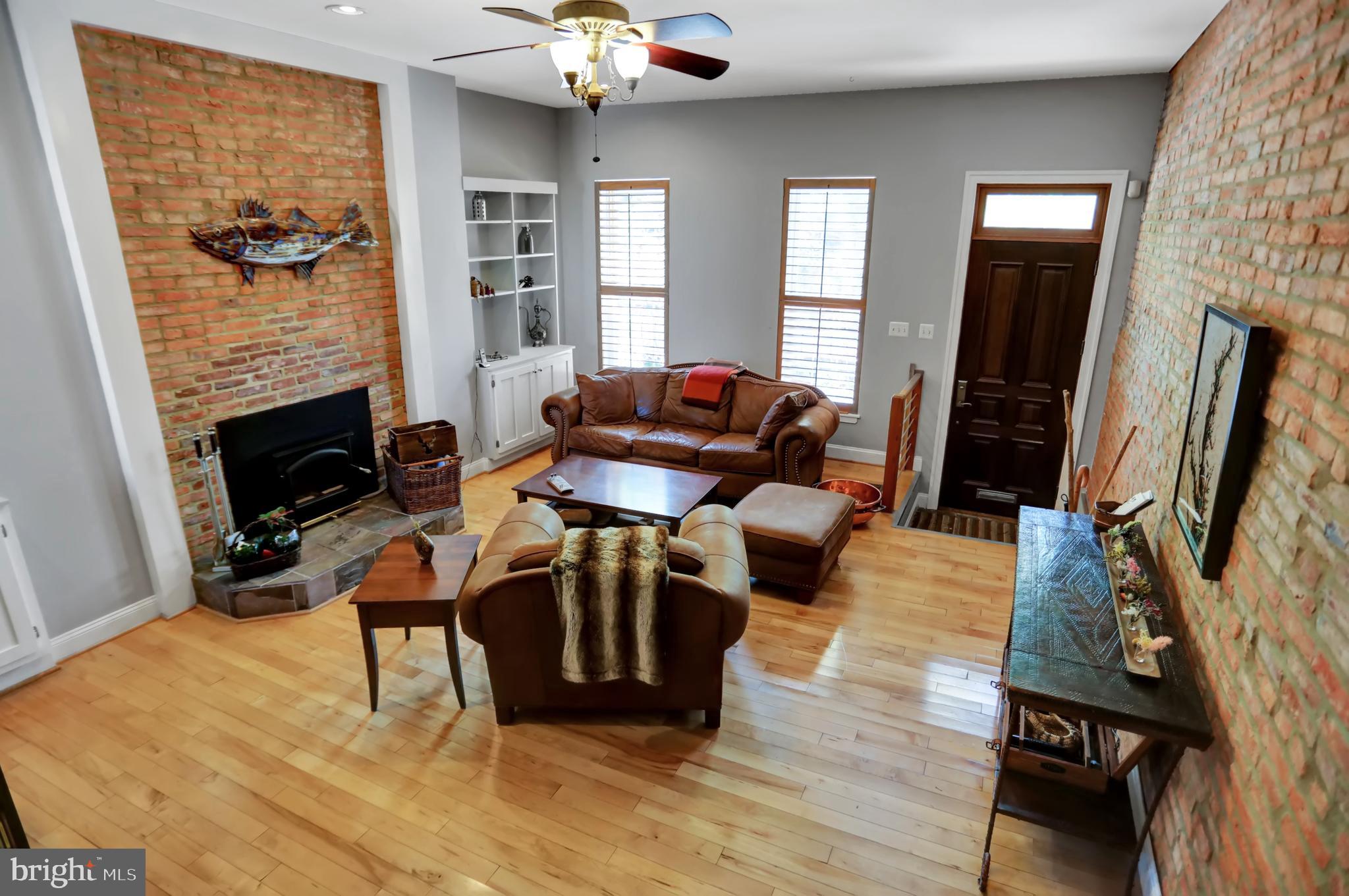 If you are getting tired of seeing the same architectural formula repeated over and over again  then stop in to see this refreshing Grand Victorian with a flair for the modern.  You would be hard pressed to find somthing comparable at this price with its many attributes. This 3 bedroom 2 full and 1/2  bathroom house  consists of 2700+  square feet of fully  renovated space.  The  townhome was completely  gutted to the bare brick and rebuilt.  Note, this is not a flip type of renovation.  Among its many interesting features is a central open staircase with a bright an airy  atrium effect. The floors throughout the house are made of maple  while the kitchen and bathroom floors are made of slate and ceramic tile.  The kitchen features a professional grade Castle stove , wood cabinetry  and granite counters.  The living room has exposed brick walls, wood floors  and includes a wood burning stove fitted into the original brick fireplace. The visual effect of the first floor is open as a view corrider exists to the the rear kitchen location.  Artistically significant, hand  crafted, iron grates cover the first floor windows and doors.  There is parking for 1 standard size vehicle or 2 Minis at the rear of the property. There are 2 decks. One of the decks is  somewhat  private and made of wood at the rear of the second floor, overlooking the parking pad, while the other is a large composite trex  deck  located on the rooftop. The rooftop deck offers views of downtown and the Johns Hopkins Medical Complex.  Incidentally, The Johns Hopkins Hospital is a mere 2 blocks from this home as is Baltimore's fist urban park, Patterson Park.  Fells Point, Harbor Point and Canton are within walking distance.