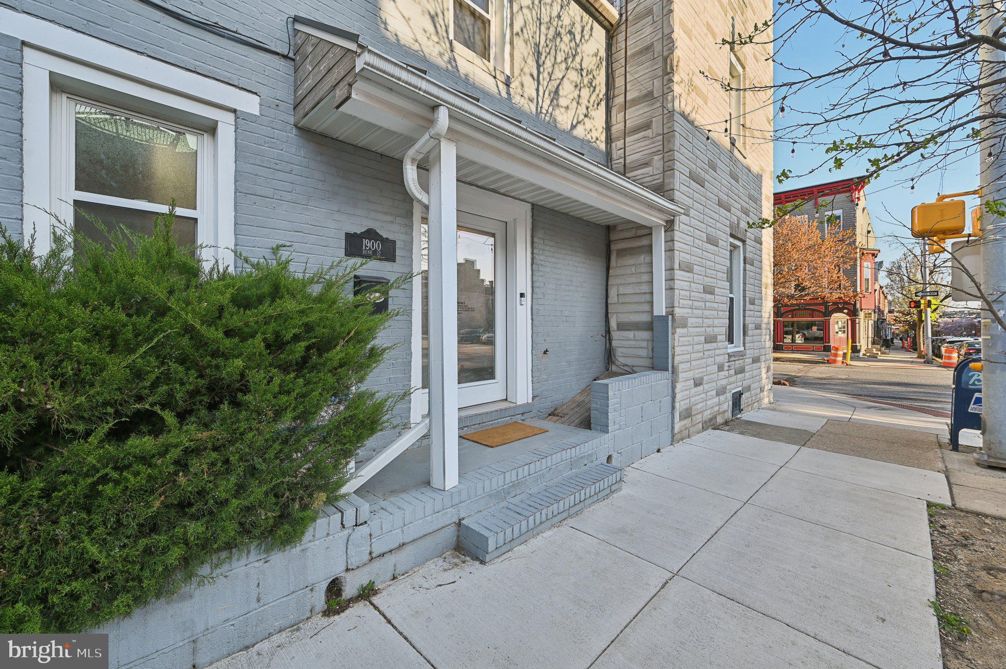 Soaked in sunlight and packed with charm, this corner-unit stunner sits on two picturesque, tree-lined streets in one of Baltimore’s most walkable neighborhoods. Just one block from NYT top-rated Little Donna’s and steps to Hopkins, Patterson Park, the waterfront, and a buzzing lineup of restaurants, bars, markets, and shops—this location hits every mark. Inside, you’ll find three spacious above-grade bedrooms, including two strong contenders for a primary suite. The living room features stylish interior shutters, and the side entrance offers smart functionality with a coat closet and bonus under-stair storage.
But the real showstopper? The private, covered back patio—rare in the city and perfect for year-round hangouts, container gardening, or simply enjoying your own slice of outdoor space. Thoughtfully designed with low-maintenance flower boxes, it also offers a tucked-away spot for secure package deliveries. There are also more than a few additional highlights which would include being a bright corner unit with tons of natural light and a (currently unfinished) basement for extra storage or finish into a trendy "home away from home" office or gym area. You'll love having no-maintenance outdoor space with year-round appeal and ultimate walk-ability to local favorites and daily essentials. City living just got an upgrade—don’t miss your chance to call this gem home.