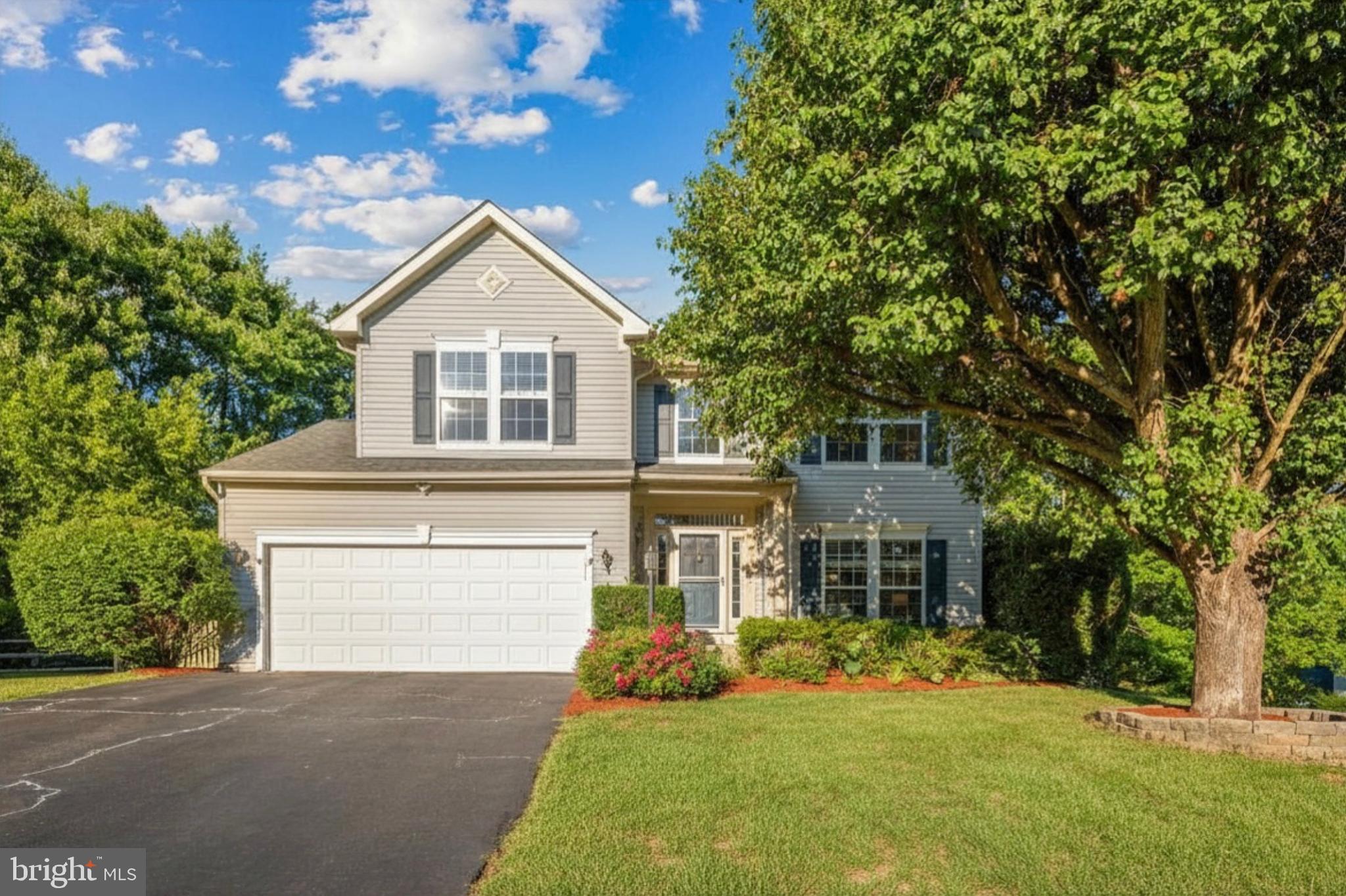 Welcome home! Nestled at the end of a quiet cul-de-sac, this beautiful five-bedroom home offers space, comfort, and timeless style across three finished levels. Gleaming hardwood floors and a dramatic two-story foyer welcome you inside, where a formal living room with plush carpeting sits just off the entry, offering a graceful first impression. From there, the space flows into a dining room wrapped in a bay window that fills the room with an abundance of natural light. Toward the back of the home, a gorgeous kitchen opens seamlessly to the family room through a corner peninsula bar, creating an inviting gathering space anchored by a cozy gas fireplace. Stainless steel appliances, sleek granite countertops, and a center island make the kitchen as functional as it is beautiful, while a sunny breakfast nook surrounded by windows invites you to linger over morning coffee. Upstairs, a generously sized primary bedroom offers a peaceful retreat with plush carpeting, a walk-in closet, and an en suite bathroom complete with a soaking tub, step-in shower, and double sink vanity. Three additional bedrooms with soft carpeting are ideal as a home office, guest room, or whatever suits your needs, and share a bright full bathroom in the hallway. Downstairs, a versatile lower level provides a carpeted recreation room, a fifth bedroom, and a third full bathroom with a step-in shower, offering wonderful private space for guests or multi-generational living, while a large storage room rounds out the level. Step outside onto your two-level wooden deck to enjoy relaxing and grilling all Summer long, all within a fully fenced backyard framed by mature trees that provide privacy, shade, and a beautiful natural backdrop. Major home updates bring lasting peace of mind, including a newer water heater (2024), HVAC (2024), as well as washing machine and dryer (2024), and recently updated kitchen appliances. At the front of the home, a two-car garage and long driveway offer plenty of room for both parking and storage. Residents enjoy access to the community's outdoor pool, basketball courts, and tennis courts. Just minutes to Giant Food, Manassas Mall, Old Town Manassas, and the Prince William County Fairgrounds. Quick access to Prince William Parkway, Nokesville Road, and I-66. Commuters will appreciate the nearby Manassas VRE station. Don't miss your chance to call this beautiful home your own - schedule your private tour today!