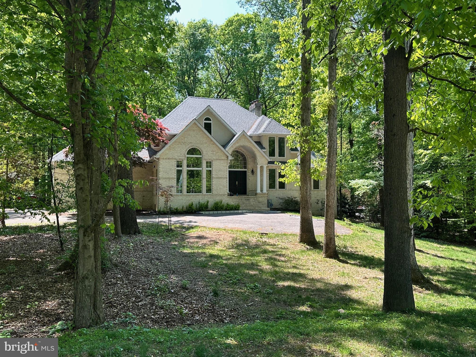 STUNNING RETREAT HOME WITH 2026 UPGRADES ON 3-PRIVATE ACRES
Tucked away on a quiet cul-de-sac and set on a picturesque 3-acre corner lot, this beautifully updated transitional home at 11801 Wollingford Court offers an exceptional blend of space, comfort, and modern upgrades. With 7 bedrooms, 4 full and 1 half baths, and a fully finished walk-out lower level, this expansive residence is designed for both everyday living and effortless entertaining.
The main level welcomes you with a grand two-story foyer, a sun-filled family room, and a highly sought-after main-level primary suite, along with the convenience of main-level laundry. Elegant hardwood floors span the living room, dining room, study, and family room, while two, double sided gas fireplaces add warmth and architectural charm throughout.
Extensively updated in 2026, the home features new carpet on the main and upper levels, fresh paint throughout all three levels, updated foyer flooring, and all-new lighting. The kitchen has been refreshed with sanded and painted cabinetry, new hardware, granite countertops, and a stylish backsplash. The fully renovated primary bath offers a luxurious retreat with a freestanding tub, frameless glass shower, new ceramic tile, quartz-topped vanities, updated lighting, and modern fixtures. Additional upgrades include enhanced upper-level baths, a refreshed powder room, and an upgraded wet bar in the lower level—perfect for entertaining.
Major system updates include a new roof (2026) with a 2-year transferable warranty, a new HVAC system for the main level (2021), and additional HVAC updates in the primary and lower zones (2015). Other key improvements include a replaced hot water heater with propane service, updated microwave and cooktop, and a water neutralizer system replacement. The lower-level carpet was replaced in 2019 and still looks brand new.
Built with quality and efficiency in mind, the home features brick on three sides with a stucco rear, 2x6 exterior wall framing with ample insulation, and lined HVAC ducts for reduced operational noise. The lower level and garage floors are steel-reinforced concrete, and the oversized 3-car garage offers high ceilings and space for larger vehicles.
Outdoor features include a private drive framed by brick pillars with lantern lighting, additional parking, a welcoming covered front porch, and a freshly painted rear deck—ideal for relaxing or entertaining in a serene setting. Propane connections service the two double-sided brick fireplaces and a rough-in located under the deck for BBQ grill and outdoor cooking.
Upstairs, generously sized secondary bedrooms include a private en-suite, while the lower level provides flexible living space with a recreation room, game area, fitness room, and two additional bedrooms—perfect for guests or multi-generational living.
With its thoughtful layout, extensive upgrades, and tranquil setting, this home offers a rare opportunity for refined living with exceptional privacy, all while remaining conveniently close to top-rated schools, shopping, and amenities.