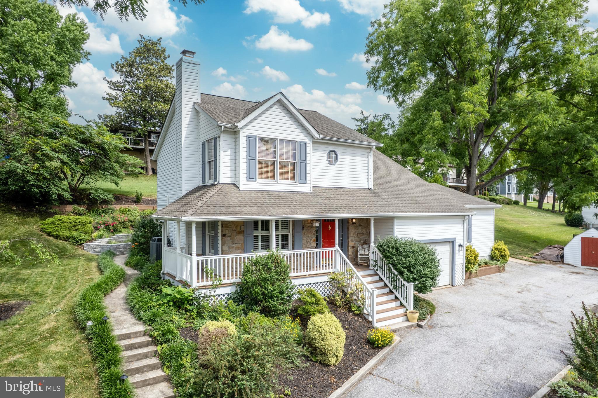 Beautiful 4 bedroom, 3 full bath home on quiet dead end street in established neighborhood, professionally landscaped on over 1/3 acre!  Very convenient location close to shops and restaurants.  Relax on the covered wraparound porch or the head to the backyard to enjoy the gorgeous landscaping and custom stone patio.  Freshly painted with hardwood floors throughout, and new carpet in the upper 3 bedrooms.  Fourth bedroom on first floor could be used as the primary bedroom or as a guest or in-law suite.  All bedrooms are generously sized, with ample storage throughout the home.   One car attached garage and private drive.   All the convenience of town living in a quiet, peaceful setting.  Don't miss out!