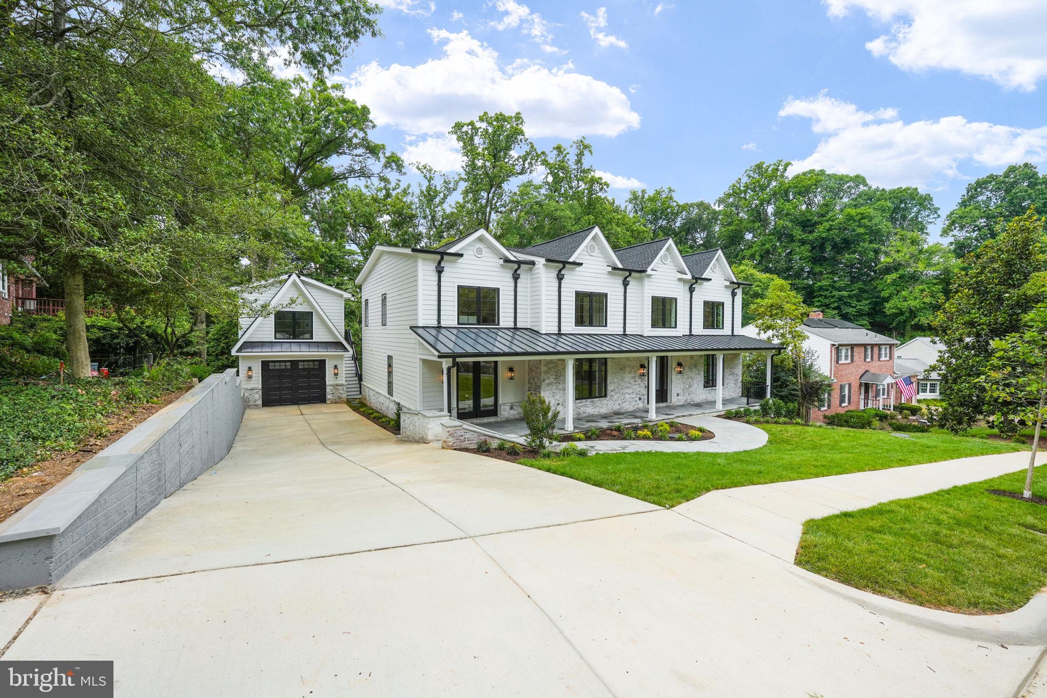 Welcome to a stunning new construction home in Alexandria City's sought-after Malvern Hill/Sterling neighborhood. This expansive residence spans over 6200 square feet across three finished levels, boasting 5 bedrooms, 4 full baths, 2 half baths, 2 fireplaces, and an accessory dwelling/guest house above the oversized garage. Approaching the home, you're greeted by a striking facade blending white-washed red brick and pristine white hardiplank, complemented by sleek black window frames and gutters. A landscaped front yard leads to a covered porch with recessed lighting and ceiling fans, setting a welcoming tone. Inside, the foyer impresses with natural light pouring through expansive windows, illuminating gleaming white oak flooring that extends throughout. Details like 7" baseboards, recessed lighting, custom fixtures, and a state-of-the-art speaker system enhance the sophisticated ambiance. To the right of the foyer, glass doors open to a spacious office with a ceiling fan, ideal for work or reflection. To the left, a formal dining room accommodates 8-10 guests, perfect for entertaining. The heart of the home is the chef’s kitchen, featuring double islands with breakfast bars, custom pendant lighting, and two-tone shaker cabinets. It's equipped with two dishwashers, two sinks, a 42" gas range, pot-filler, microwave, and striking white quartz countertops with grey veins. Adjacent, the breakfast area flows into a large living/family room highlighted by a marble gas fireplace. French doors lead from the family room to a spacious Trex deck with outdoor lighting and speakers, overlooking a private backyard with lush greenery—a serene retreat. The main level also includes a thoughtfully designed half-bath and a mudroom with full-size washer and dryer, shaker cabinets, sink with disposal, and built-in storage bench with hooks. A glass entry door provides easy access to the rear. A large in-law suite with private entrance features a double closet, Sonos speakers, ceiling fan, and luxurious en-suite bath with marble vanity and spa shower. Ascending the staircase, custom picture frame molding lines the hallway leading to bedrooms with recessed lighting, ceiling fans, and additional amenities like a secondary washer and dryer. The master suite offers a tray ceiling, Sonos speakers, marble gas fireplace, walk-in closet with custom built-ins, and a luxurious spa-like bathroom with skylights, marble accents, soaking tub, and glass door spa shower with dual heads. Two generous bedrooms each boast walk-in closets and lavish baths, while two additional bedrooms share a large Jack and Jill bath. The fully finished basement features luxury vinyl flooring, recessed lights, Sonos speakers, and ample storage. A wet bar with quartz countertops and subway tile backsplash is perfect for entertaining, along with a movie room equipped for cinematic experiences. A half bath, bedroom with full bath, and finished storage room complete this level. An oversized one-car garage with a long driveway accommodates multiple vehicles, with an accessory dwelling/guest house above. This space includes a bedroom set, full bath, galley kitchen with appliances, utility closet with washer/dryer, and separate water heater and furnace. Meticulous attention to detail is evident throughout, from architecture and designer finishes to paint, flooring, moldings, cabinetry, fixtures, and utilities. This dream home blends luxury with convenience, offering proximity to shopping, dining, parks, and transit, including easy access to Pentagon, Amazon HQ2, Reagan National Airport, and Downtown D.C. Enjoy residing in a quiet neighborhood with access to Duke Street, I-395, King Street Metro and VRE, and the Bradlee Shopping Centre. Don’t miss this rare opportunity to own an exceptional home in a prime location.
