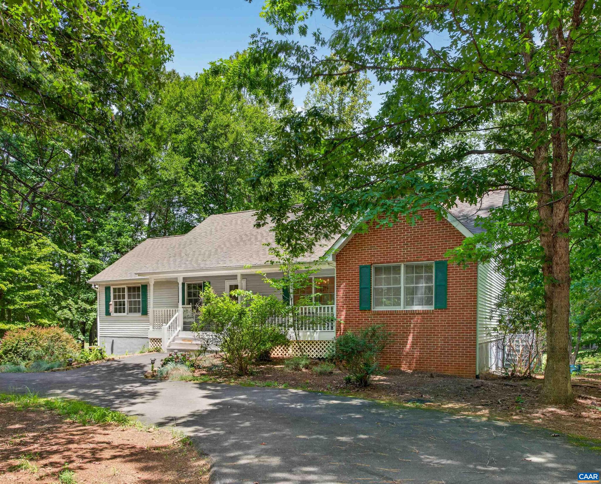 Golf-front living in a fabulous Lake Monticello location! Set on over half an acre along the first fairway, this 4-bedroom, 3-bath home offers wonderful space, views, and potential. The main level welcomes you with vaulted ceilings, skylights, hardwood floors, a Gas fire place and open living, dining, and kitchen areas.  A spacious screened porch overlooks the fairway, with an adjacent open deck accessible from the primary suite.  The primary bedroom is privately situated on one side of the home and features golf course views, deck access, walk-in closet, and an en-suite bath. Two additional bedrooms share a full hall bath. The terrace level offers a versatile family/rec room with walk-out access to the backyard, along with a fourth bedroom, full bath, laundry, abundant storage, and a convenient one-car garage.  Outside, enjoy an inviting front porch, a paved U-shaped driveway with ample parking, and a large golf-front lot enhanced by a fire pit and putting green. Located just a short walk from Bunker Park and minutes from the Fairway Clubhouse and Bistro, this property is ready for its next owner to bring their vision and make it their own.,Tile Counter,Fireplace in Great Room