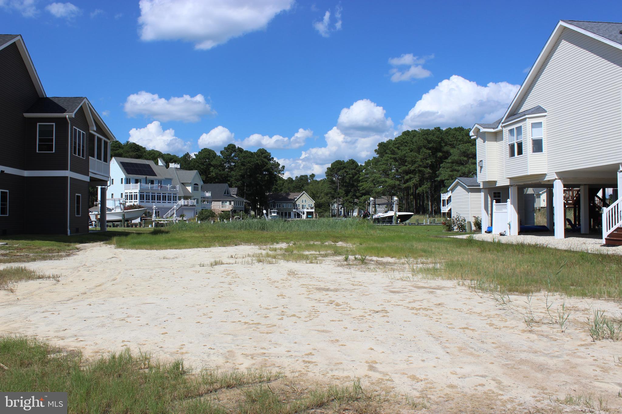 1/933 Location, Location, Location! One of the best waterfront properties in Captain's Cove that offers a very large building window and Chincoteague Bay views. Take in all the sunrises over the bay. Protected canal front lot that feeds directly into the Chincoteague Bay, come and see for yourself and you will agree! To appreciate the view I encourage you to step outside your car and walk to the back of the lot...PRICELESS!!!! Approx. 61' of New Vinyl bulkhead . Great value! HOA amenities: Prestine 9 Hole Golf Course, indoor/outdoor pools (2), fitness center, pickle-ball & basketball courts, playground, boat ramp, picnic area, dog park, biking & walking trails, security and so much more. Call for more information.
