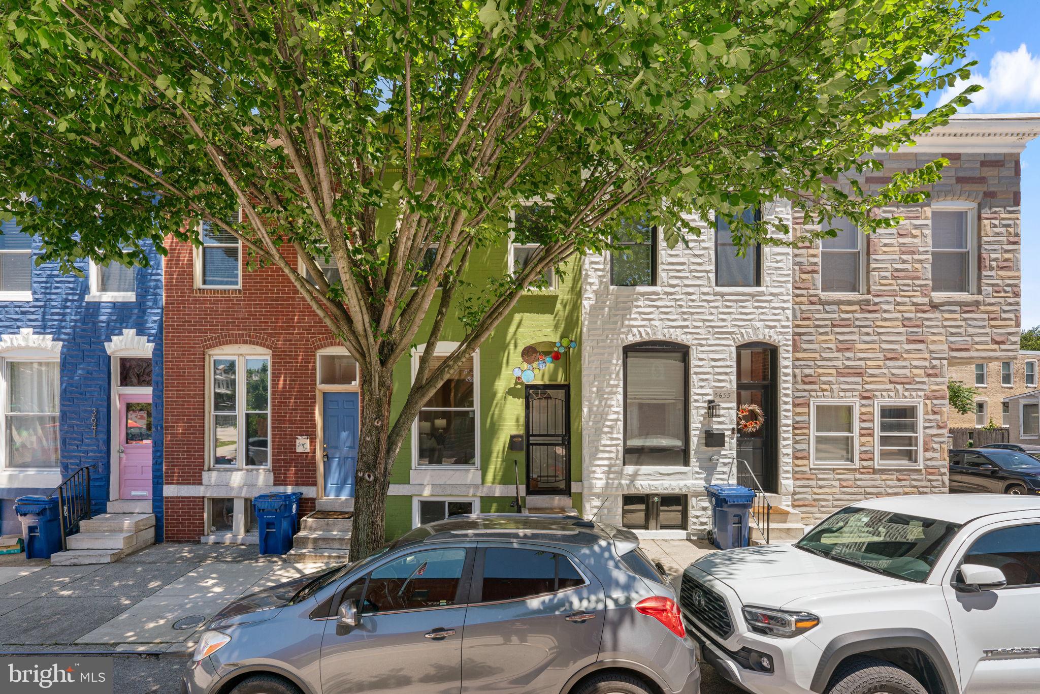 Thoughtfully updated and impeccably maintained Federal-style townhouse residence offering 3 bedrooms, 1.5 bathrooms, and 1,598 finished square feet in the heart of vibrant Hampden. // Move-in ready and filled with natural light, the interior showcases fresh linen-inspired paint throughout, recently installed Mannington luxury vinyl plank flooring across the main and upper levels, Shaw carpeting, recessed lighting, and custom fixtures. // The welcoming main level begins in a bright living room framed by oversized picture windows and flows seamlessly into the stunning kitchen and dining area. Designed with both style and functionality in mind, the kitchen features quartz countertops, upgraded 42-inch soft-close white cabinetry with pan drawers, recently installed stainless steel appliances, including a stove (2023), refrigerator, and dishwasher (2026), under-cabinet lighting, a classic white subway tile backsplash, exposed brick accents, track lighting, and deck access. Adjacent to the kitchen, the spacious dining area comfortably accommodates a full-size dining table, while a convenient powder room completes the main level. // Newly carpeted stairs lead to the second level, where a full bathroom offers a modern interactive vanity mirror.  The spacious owner's suite offers exceptional storage with two closets, and a secondary bedroom provides comfortable accommodations. The walk-up lower level is clean, highly functional, and partially finished with excellent ceiling height, offering laundry facilities and exciting potential for additional living space. A versatile third room, though not a legal bedroom, offers flexibility as a home office, den, guest space, or creative studio. // Outdoor living is equally inviting with a low-maintenance two-tier composite deck, partially covered for year-round enjoyment, overlooking a quaint private rear yard enclosed by privacy walls. Additional updates include a water heater replaced in 2020, a natural gas HVAC system replaced in 2022, and windows and a rear exterior door replaced in 2024.  // Located within a quiet residential setting, yet just moments from the best of Hampden, the home enjoys direct access to a school, park, and green space across the street, along with convenient proximity to I-83, local restaurants, shops, ice cream and pie destinations, and the neighborhood's beloved festivals and community events.