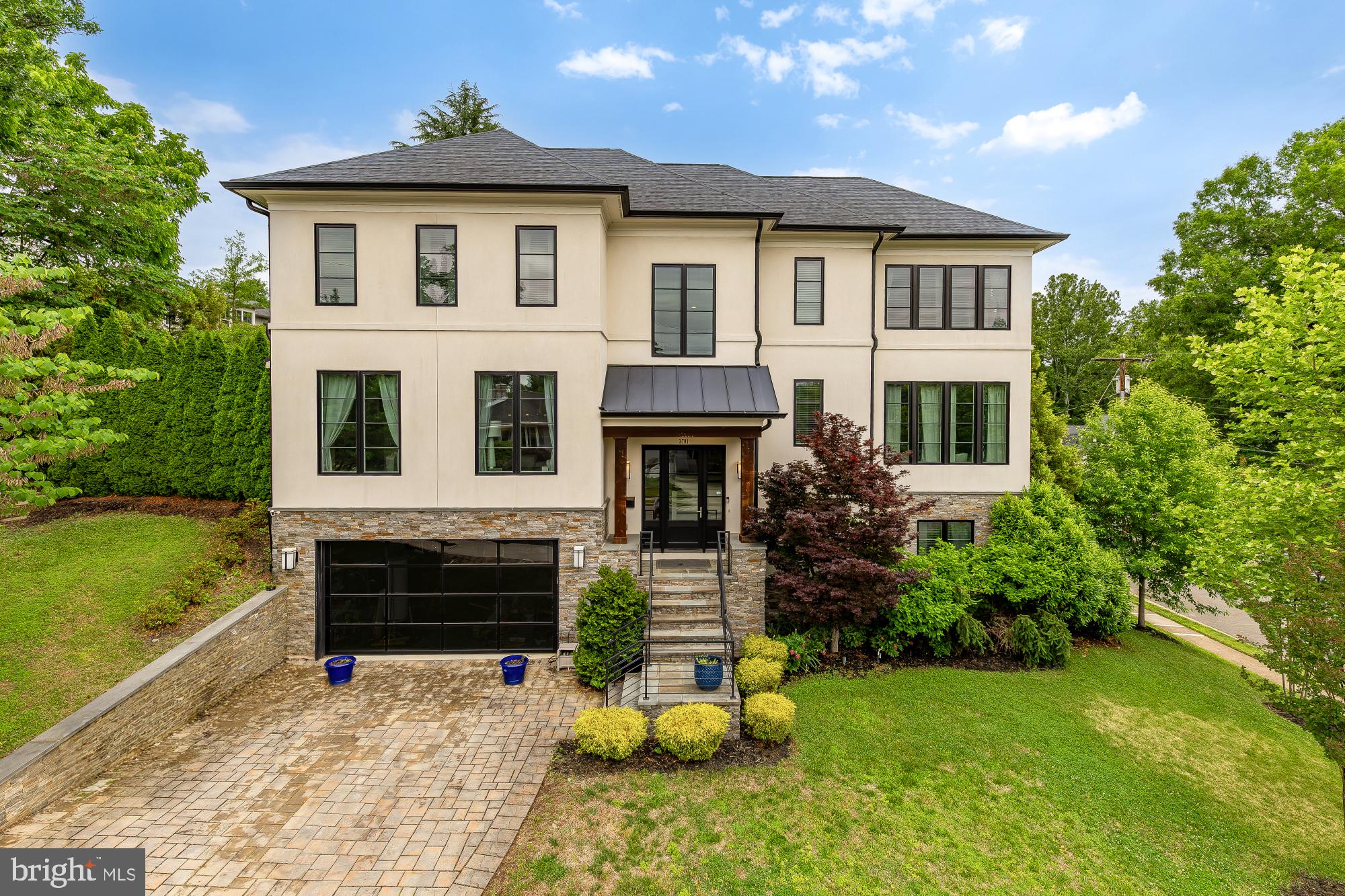 An exquisite New Contemporary residence of rare distinction, masterfully crafted with premium stone and authentic stucco exteriors that exude modern elegance and enduring sophistication. This 6-bedroom, 5.5-bath sanctuary (approximately 5,600+ sq ft) unfolds in a fluid open-concept design, crowned by a dramatic formal Conservatory with soaring 12-foot ceilings and a striking granite accent wall framing a sleek linear fireplace.

The heart of the home reveals a chef-caliber Kitchen flowing effortlessly into a luminous Morning Room and expansive Family Room, where walls of 10-foot glass doors dissolve boundaries to reveal a private resort-style retreat: a meticulously designed patio graced with a built-in barbecue, indulgent hot tub, and inviting fire-pit perfect for al fresco gatherings under the stars or serene evenings alike.

The luxurious primary suite offers a spa-inspired bath and voluminous walk-in closet, while a sunlit private Office anchors the main level and a versatile bonus room enhances the bedroom level. A newly envisioned top-floor au pair or nanny suite provides complete privacy with its own full bath and abundant closet space, ideal for multigenerational living, guests, or dedicated support. Complemented by an additional bedroom for enhanced flexibility.

Professionally landscaped grounds illuminated by elegant outdoor lighting complete this singular offering of uncompromising quality and contemporary grace in one of Arlington's most coveted enclaves.
