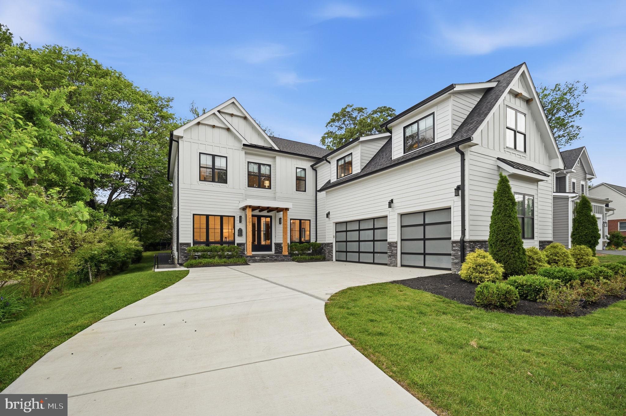 Exquisitely crafted and impeccably maintained, this 5-year-old modern craftsman style home  offers over 6,200 sq. ft. of refined living space on a rare oversized flat lot in the Town of Vienna. A truly exceptional residence, it features a 3-car garage, artisan siding, stone foundation, 10-foot ceilings on the main and upper levels, extra-height Andersen windows, hardwood flooring throughout both levels, custom metal stair railings, and an irrigation system. At the heart of the home, the chef’s kitchen is designed to impress with Thermador appliances, a 48-inch gas range, an oversized island, a Butler’s Pantry, and striking exposed cedar beams. The main level is tailored for both elegant entertaining and everyday comfort, and includes a private bedroom suite with full bath, custom shelving, and a queen-sized Murphy bed—ideal for guests, multigenerational living, or a sophisticated home office. Upstairs, four spacious en-suite bedrooms include a magnificent primary retreat with vaulted ceilings, a spa-inspired marble bath with soaking tub and separate shower, and an expansive custom closet. The elevator-ready design continues into the walk-out lower level, where a full wet bar, generous great room, media room, two additional bedrooms, a full bath, and abundant storage create an ideal extension of the home’s luxury living space. Outdoors, a stunning two-story deck overlooks the flat backyard, offering a beautiful setting for relaxing or entertaining. All of this is just minutes from downtown Vienna, Tysons Corner, and major commuter routes, and within the highly sought-after Madison/Thoreau/Marshall school district.