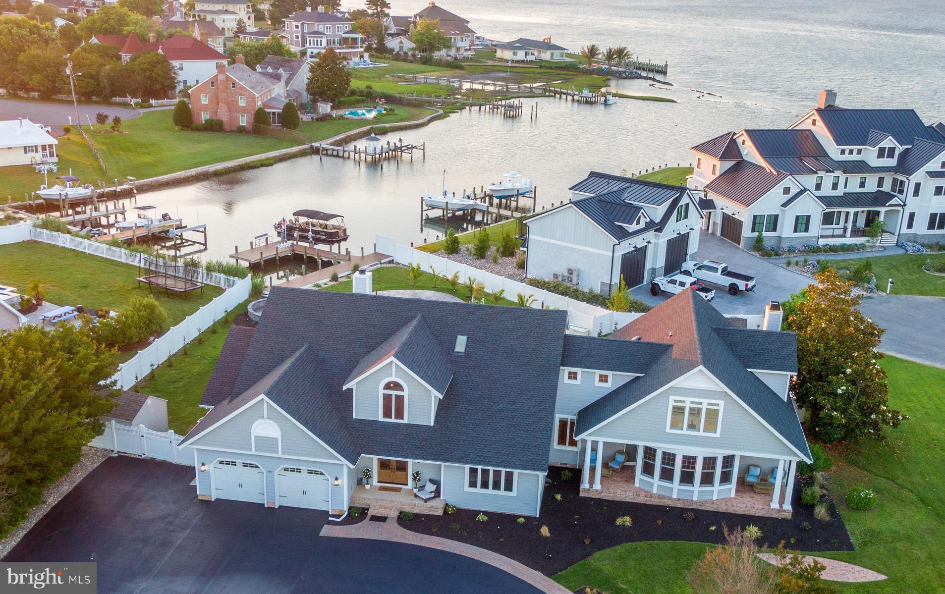 Welcome HQME to 13023 N Shore Rd. – a haven of refined luxury and tranquil waterfront living in Captain’s Hill, one of Ocean City’s most coveted neighborhoods!  Located directly on the Bay, with easy access to Assateague Island, downtown Ocean City and many local marinas, this location is ideal for a large family retreat or an everyday residence in a quiet community.  This stunning property has been recently renovated to perfection and boasts an array of sophisticated features, built with functionality and ease of entertaining in mind.  Step inside to discover a meticulously designed interior, featuring an open floor plan with durable LVP flooring throughout that seamlessly blends spaciousness with comfort and utility. The gourmet kitchen is built to impress with an 8-burner stove, dual dishwashers, dual sinks, an insta-hot, tons of storage, access to the large screen porch and an over-sized island with plenty of seating!  High ceilings, expansive windows, and designer lighting throughout the main level provide an abundance of natural light and the ability to soak in the views of Assawoman Bay and the beautifully appointed backyard.  The main level also contains, a generously sized second master with large en-suite bath and access to the rear deck, a second main level bedroom with en-suite bath that is also accessible via the deck, a dining area, 2 powder rooms, 2 sitting areas, a second laundry room and a huge rec room with wet bar and pool table!  Pass through the 500 sq ft screen porch and you won’t be able to resist the newly re-surfaced salt water pool with propane heater!   The private dock contains an 8,000 lb boat lift, as well as plenty of other docking space for small watercraft.  There is also a built-in playground area for the little ones and a shed for storing your water toys.  Upstairs, you will find 3 more large bedrooms, 2 of which have private balconies and newly updated en-suite bathrooms!  There is a third upstairs bedroom, full hall bathroom, second floor laundry room, and 2 bonus rooms that could be used as additional space for guests.  This exceptional property represents a rare opportunity to own a luxurious retreat in a prime waterfront location - Ocean City, MD is 3 hours from each Philadelphia & DC; 4 hours from NYC and hosts some of the best fishing tournaments on the East Coast!   Whether you seek a peaceful oasis, a place to entertain in style, or a new home base in a beautiful setting, 13023 N Shore Rd offers the ultimate in coastal living.  Schedule your private tour today and experience the epitome of luxury waterfront living firsthand!  Furniture negotiable.