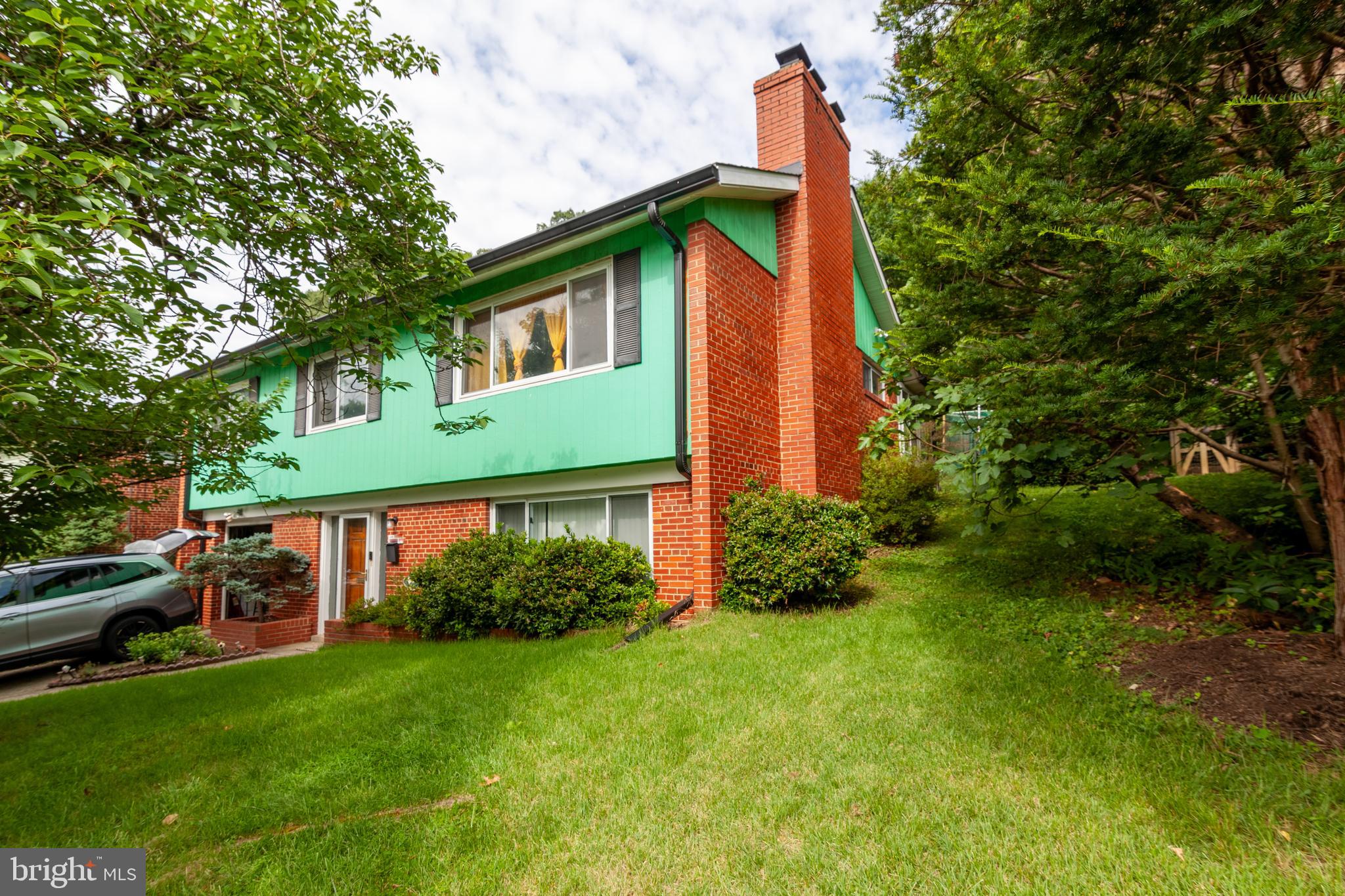Spacious and updated 2-story raised rancher on a quiet street in Northwood Park View. The main level highlights beautifully refinished hardwood floors, a bright living room anchored by a wood-burning fireplace, a separate dining area, and a sunroom. The kitchen features timeless Corian countertops, a glass-top stove, and a seamless integrated sink. The fully finished daylight basement offers a large family room with a second wood-burning fireplace, a full bath, and direct walk-out access to both the front and side yards, plus interior access to the 1-car attached garage. Outside, the private backyard includes an expansive patio with a built-in gas grill—perfect for entertaining. Move-in ready and full of charm.