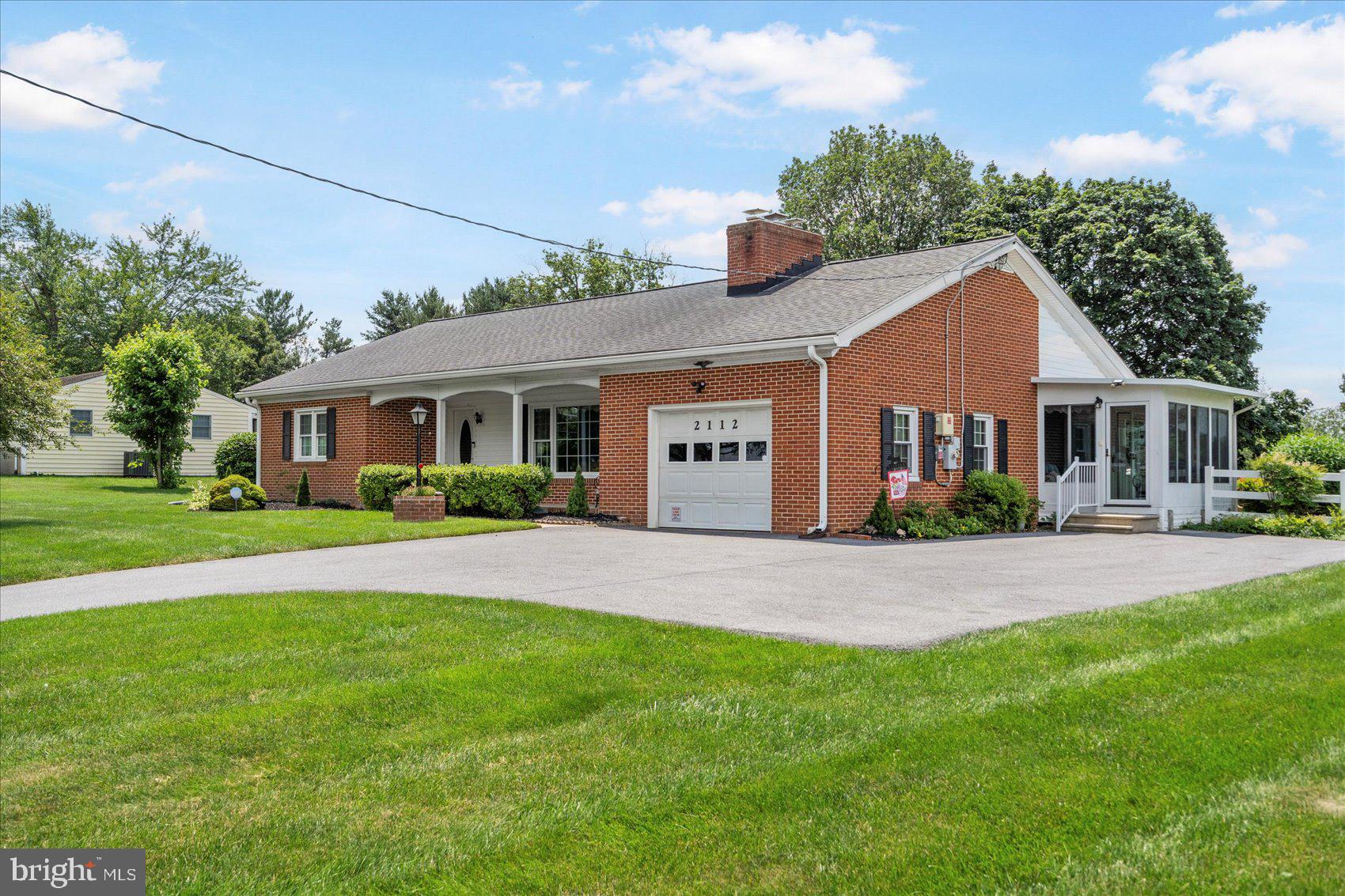 This large, brick Ranch-style home offers the best of all worlds – a rural, scenic, and peaceful setting surrounded by pastures, mature trees, and beautifully landscaped acreage, all just a minute from  Rt. 97, and then everything you love about the city of Westminster.   The highlights of this wonderful home are the hardwood floors throughout and the HUGE 20 x 16.5 ft. Living room with a large picture window that brings in plenty of natural sunlight to brighten your day.  Add the wood stove, and you have the perfect place to relax or entertain, day or night, for every season.  Enjoy your formal dining room, complete with built-in corner cabinets for all your cherished dining essentials.  A few steps from there, and into your new country-style Kitchen, featuring stunning quartz countertops, stainless steel appliances, and tons of cabinet space.  From there, step through the side door and out onto your large, three-season Sunroom where you can enjoy your coffee and paper in the morning and your cocktails in the evening as you watch the sunset over stunning views.   This unique home has three (3) large bedrooms and two full ceramic tile bathrooms.
Additionally, a room in the finished basement could serve as a fourth bedroom.  Your huge, finished basement features many built-in custom elements, including a built-in bar, a built-in office and desk, built-in benches for seating, and ample storage space.  There is even a separate room that is ideal for a workshop or craft room, or BOTH!
Updates throughout the home include new, energy-efficient windows, solar panels for reduced electricity bills, roof, HVAC system, fencing, driveway, gutter guards, and a brand-new water filter and conditioning system for delicious, cool, crisp water.  Plus a barn/shed for storage or an outdoor workshop.
This Gorgeous Home and Property have been lovingly cared for, and it shows.  Sitting on .67 acres, this big, spacious home rewards you and your family with the quiet enjoyment of nature all around you, but close to everything you need.   It's like your very own private retreat.
Once you come to visit, you will call it Home!
