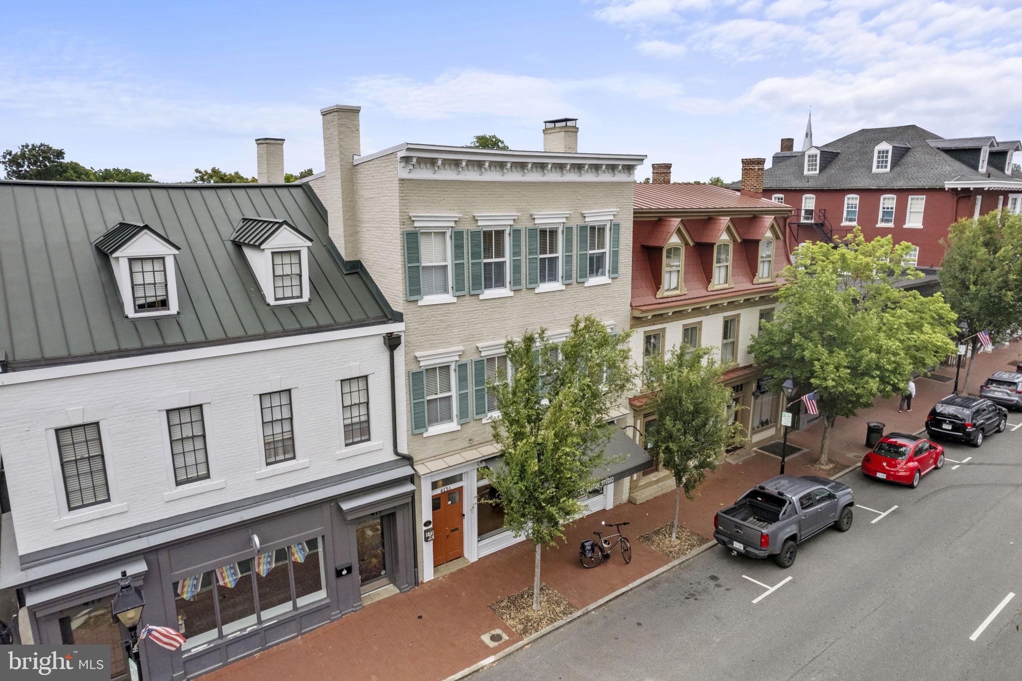 Unique  Beautifully Renovated  Mixed-Use Historic Building in Downtown Fredericksburg . 3 income producing units totaling 4435 sq ft.
OWNER Financing available !  With 30% down, owner financing @ 5% for 5 years with a balloon.
One of a kind, beautiful turnkey mixed use Historic Building in Downtown Fredericksburg. Stunning brick exterior featuring Spanish Cedar shutters. Located on Restaurant Row and close to all local shops. One commercial space and two separate living spaces, including an independent cottage totaling 4,435 sq. ft. Like new building renovated by an award winning, local Contractor. Off street compact parking with six spots (2 for each unit). All paving, both parking and courtyard are permeable. Introducing the ultimate mixed-use property located in the heart of downtown - a place where city living and income potential are perfectly intertwined! This property offers endless possibilities for both residential and commercial use. Featuring a modern storefront on the ground floor, entrepreneurs have the opportunity to set up shop and tap into the bustling downtown market. Meanwhile, residents can look forward to luxurious living spaces upstairs with breathtaking views of the city. If you're searching for a mixed-use property with great income potential and luxury living, then this is your perfect investment opportunity! This stunning mixed-use property combines convenience, versatility, and modern design to create an exceptional lifestyle for you.
415 William Street (Commercial Use)
Beautiful, 1332 sq. ft open floor plan commercial space with oversized retail windows, 10 ft ceilings, and new rear addition. Accents of exposed brick, new hardwood flooring, new Geothermal HVAC, new electrical and plumbing, and separately metered electric service. One  handicap accessible bathroom. Access to the basement with the hinged floor door. Plenty of storage with an interior closet in addition to  two exterior closets protected by an enclosed gate. Shared use of the back patio. Off street compact parking with two spots.
415-A William Street
Two stories, 2,306 sq. ft space with endless possibilities. Entering the foyer, the gorgeous hardwood steps guide you to the spacious 2nd floor with 10 ft. ceilings and hardwood flooring throughout. The half bathroom features a pedestal. Moving in the first room you will find a gorgeous brick fireplace (rebuilt) and oversized windows. Flowing into the second room, with a matching brick fireplace (rebuilt) you will find a useful closet.  An additional third room is perfect for a private workspace. Completing the 2nd floor is the large eat-in kitchen and family room(new rear addition)featuring white cabinetry, stainless steel appliances (2020), gas range, walk in pantry, and a large additional closet that could be converted for an elevator to the rear patio. Large skylights  allow natural light to gleam throughout the family room. Enjoy access to the back deck (2022), along with access to the shared patio. Moving to the third-floor landing, you will be greeted by the full bathroom with tile flooring, tile shower and washer/dryer. Built-in closet storage throughout the hall. Transom windows in each doorway allow natural sunlight to flow. 3 rooms and an additional bathroom complete the third floor. New plumbing, electrical, insulation, baths throughout. Separately metered electric service and Propane gas service. Geothermal HVAC. Off-street compact parking with two spots.

415-B
New, gorgeous cottage with 797 sq. ft. built with ICF’s, producing a very energy efficient and quiet building. The open floor plan includes a full kitchen with white cabinetry, white appliances and pantry. 1 full bathroom with walk-in shower, oversized vanity and stacked washer and dryer. 2nd floor loft with closet featuring commercial grade carpet flooring. HVAC by wall mounted “split” systems. Separately metered electric service. Shared use of private patio. Off-street compact parking with two spots.