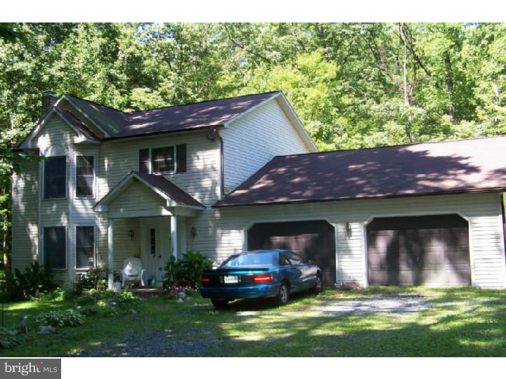This is a Must See!  Ready for Immediate Possession!  Priced to Sell!  This home is in need of a TLC, but the potential is endless.  Located on 8.5 wooded acres in beautiful Berks County the property offers privacy while still being convenient to town. Entrance into the Foyer to the spacious Living Room with Bay window or down the hall to the large Kitchen with Center Island/bar.  Extended 2 car garage allows for extra storage or workbench.  Second floor has a full bath with two bedrooms and the Master Bedroom with another bay window and large closet.  The deck located at the back of the house provides quiet private area with creek view.  Located on the property are several outbuildings, some you may choose to keep others maybe not, but there is plenty of room for storage on the property.