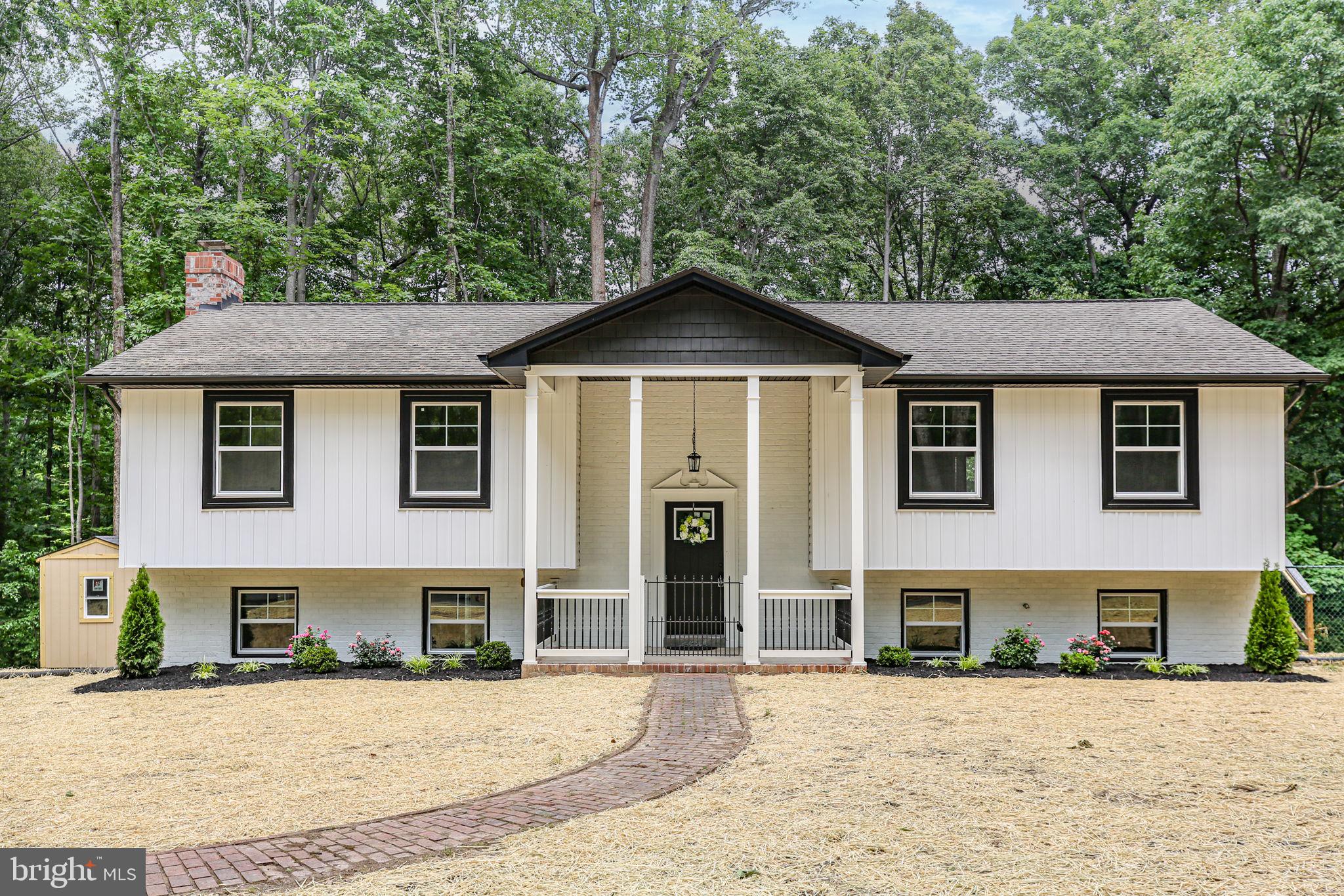 Welcome to 211 Hardwood Lane, a beautifully renovated home nestled on 2.67 private wooded acres at the end of a cul-de-sac in Spotsylvania County. Offering nearly 2,700 finished square feet, 3 full bathrooms, and a finished lower level, this property combines designer finishes with the space and privacy buyers are searching for.
Inside, you'll find a thoughtfully reimagined interior featuring an open-concept layout, designer lighting, premium finishes, and a stunning kitchen complete with stainless Bosch appliances, custom cabinetry, and modern touches throughout. Hardwood flooring extends through the upper-level bedrooms, adding warmth and character to the beautifully updated living spaces.
The spa-inspired bathrooms showcase floor-to-ceiling tile surrounds, stylish vanities, and elegant fixtures rarely found at this price point. The finished lower level includes a kitchenette and additional flexible living space, offering endless possibilities for entertaining, recreation, guests, a home office, or multigenerational living.
Major improvements provide peace of mind, including new windows, a serviced HVAC system, serviced fireplace, and recently serviced septic system. Every detail has been thoughtfully addressed, creating a truly move-in-ready home.
Outside, enjoy the peaceful setting from the expansive Trex deck overlooking the wooded acreage. A newly paved circular horseshoe driveway creates an impressive first impression while providing ample parking for family and guests. The detached shed offers additional storage and workspace options.
Move-in ready and renovated from top to bottom, this property offers the rare combination of acreage, privacy, designer finishes, flexible living space, and modern convenience—all just minutes from shopping, dining, commuter routes, and everyday amenities.