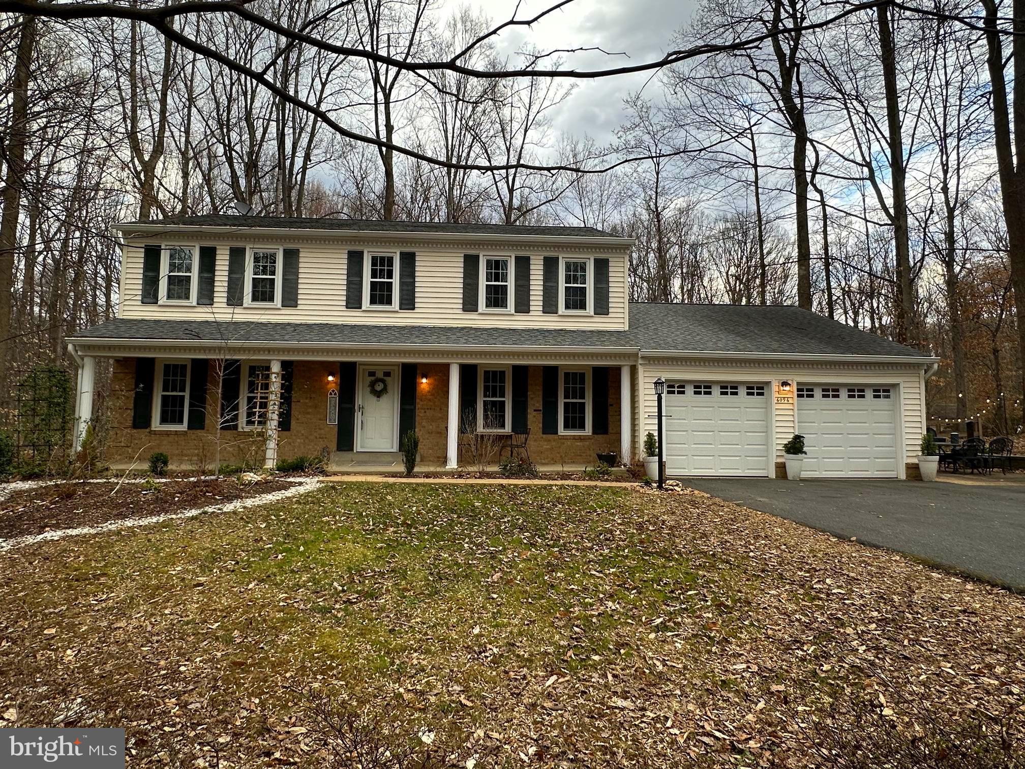 This beautiful colonial is nestled on more than an acre in a private and secluded section of Fairfax Station. A long driveway leads up to a parking pad for at least 4 cars and a welcoming porch with serene views of the front yard.  The main level includes a living room, an office with built-ins, a formal dining room, a spacious kitchen with granite counters,  a breakfast area with doors leading to your large deck, a family room with a wood burning fireplace, and a mudroom with laundry leading to the 2 car garage. The upper level includes a spacious primary bedroom with a walk-in closet and an ensuite spa-like bath, a hallway bath and three additional large bedrooms. The lower level has a large family/recreation room, a  fifth bedroom, a workshop, a craft room with a closet and desk area and doors leading to an exterior patio and your expansive  yard. The home is conveniently located close to Fairfax County Parkway and the VRE for commuting to downtown DC,  the Pentagon and major airports.