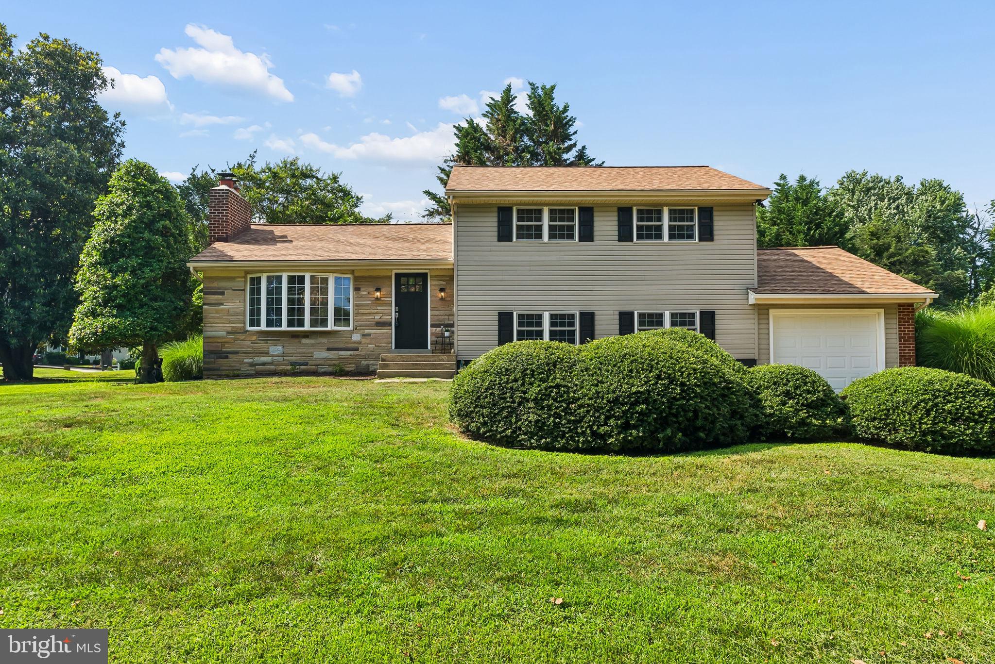 Nestled in the heart of Hillsmere Shores, this beautifully updated 3-bedroom, 2-bath split-level is just two blocks from the community's private beach and playground on the South River, where residents enjoy breathtaking Chesapeake Bay views and watch sailboats and commercial ships pass by. Inside, you'll find a flexible floor plan with multiple living spaces, including a welcoming living room featuring a pellet fireplace insert, a spacious family room, and an additional finished lower-level room ideal as a playroom, home office, gym, or guest space. Hardwood flooring extends throughout two levels, with luxury vinyl plank flooring on the remaining two. The kitchen has been updated with new quartz countertops and has stainless steel appliances, while both bathrooms feature beautifully renovated showers. A convenient mudroom/laundry room provides direct access to the attached one-car garage. From the kitchen you will step down onto a paver patio for outside entertaining.  Enjoy all that Hillsmere Shores has to offer, including a private beach, marina, community pool, boat ramps, playgrounds, and year-round neighborhood events, all just minutes from downtown Annapolis.