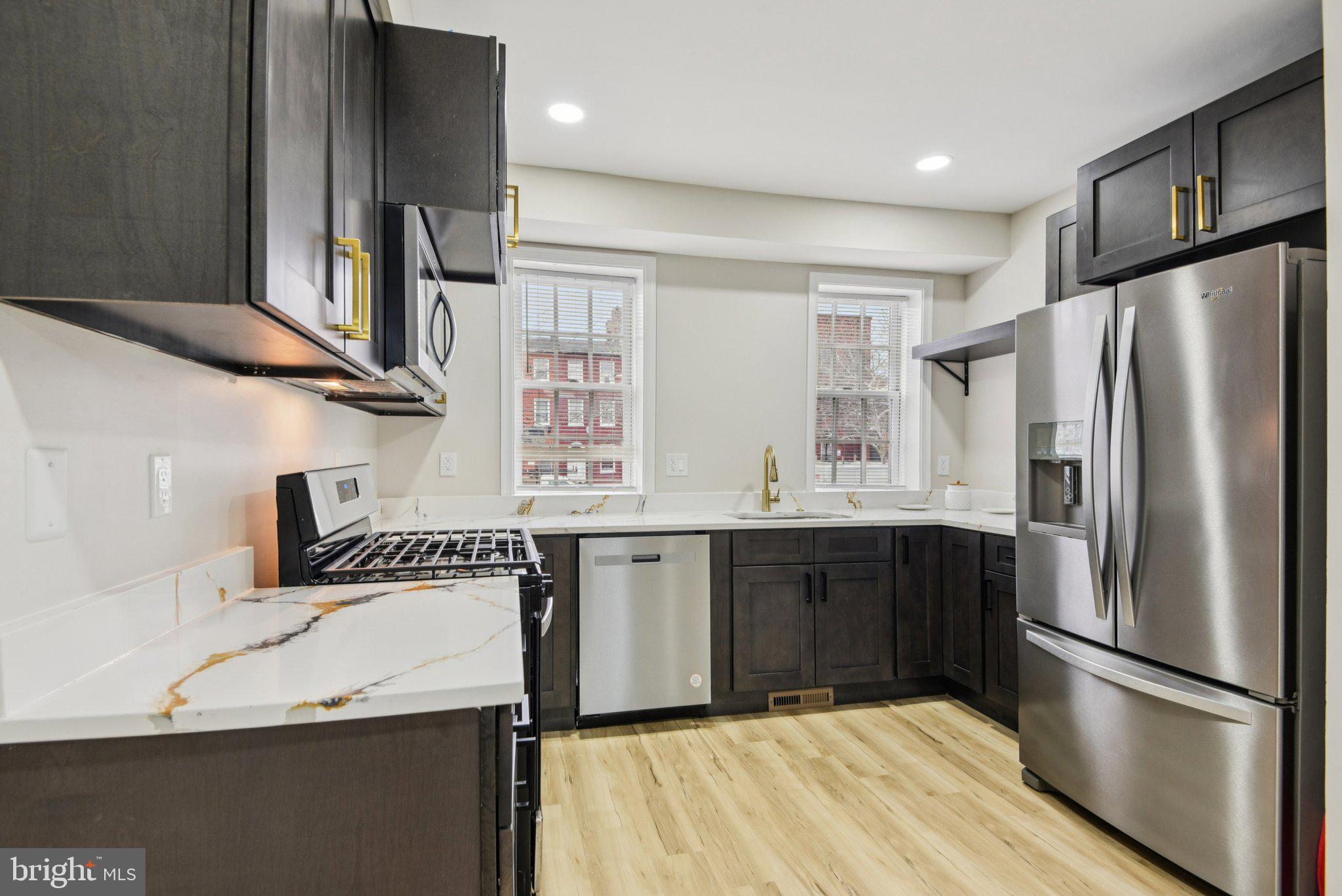 Priced UNDER $300K!!!  COMPLETE RENOVATION & additional updates in January 2026! This stunning four-level Fells Point masterpiece may qualify for first-time buyer credits and grants (subject to borrower eligibility).

Step inside and experience the elegance of the Gilded Age seamlessly blended with modern luxury. The fully renovated lower level offers exceptional flexibility, featuring a full bath with a luxurious walk-in shower, laundry area, utility space, and abundant storage. With a separate, gated street-level entrance, this level is ideal for guests, extended living, or added convenience.

The main level—also accessible via a separate entrance—continues the charm with a gourmet kitchen showcasing two-toned cabinetry and high-end appliances, perfect for culinary enthusiasts. The living area is complemented by a stylish powder room and opens to a brand-new deck overlooking a backyard ready for your gardening or entertaining vision.

The second level hosts a sprawling primary suite with raised ceilings, a skylight, walk-in closet, additional hallway storage, and a private full bath. Step out onto the second deck to enjoy morning coffee or evening cocktails in a serene setting.

The upper level features two additional generously sized bedrooms, offering ample space for family, guests, or a home office.

Live like royalty in this rare Fells Point gem where every detail has been thoughtfully designed to elevate your lifestyle. Don’t miss your opportunity to own a beautifully reimagined piece of history—schedule your private showing today!
