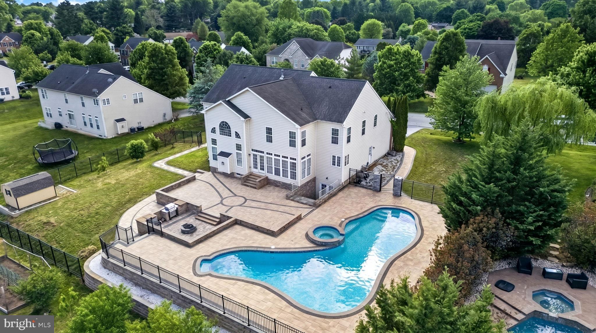 Summer dream home awaits! Make a splash in this stunning 7,000+ sq. ft. estate featuring a luxury in-ground swimming pool with a hot tub that beautifully cascades into the pool, extensive hardscaping, sauna, spa amenities, and much more.

Step into the grand two-story foyer accented with natural oak hardwood flooring. The formal living room is conveniently located off the foyer, while the impressive two-story family room showcases a gas fireplace, Palladian windows, and a stunning overlook balcony.

The gourmet kitchen features custom cabinetry, granite countertops, and stainless steel appliances. The main level also offers a private office and powder room.

Retreat to the luxurious owner’s suite complete with a sitting area and two walk-in closets. The owner’s bath includes a soaking tub and separate shower. A private guest suite with its own full bath provides excellent accommodations, while Bedrooms 3 and 4 share an additional full bathroom on the upper level.

The fully finished lower level is designed for relaxation and entertainment, featuring a sauna, spa tub with jets and advanced spray systems, stylish bonus rooms, a spacious family room, and walk-up access to the backyard.

Outside, enjoy your own resort-style backyard designed for entertaining, relaxing summer days, and unforgettable gatherings. This extraordinary property truly has it all!