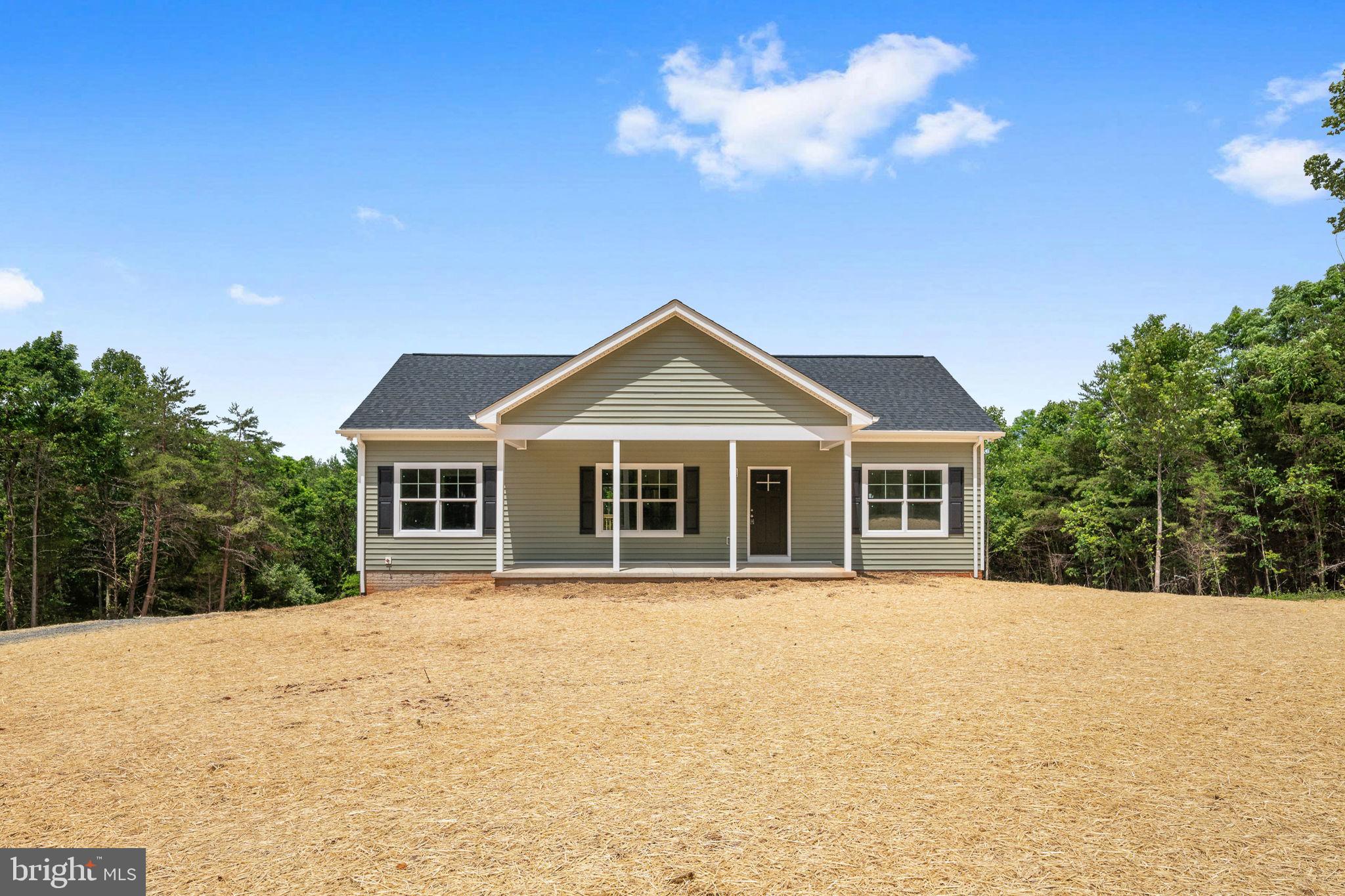 CONSTRUCTION COMPLETED — MOVE IN THIS SUMMER!  
Discover this charming 3BR/2BA home with a full unfinished walkout basement on 2.13 unrestricted acres, perfectly tucked away at the end of Peace & Quiet Circle. The wooded setting offers privacy, while the open yard provides room to play, garden, or simply enjoy the outdoors.  A wide, welcoming front porch sets the tone—plenty of space for rocking chairs, a porch swing, or your favorite outdoor décor. Out back, a large 10x12 deck is ready for summer cookouts, morning coffee, and evening relaxation.  Step inside to an inviting open-concept living room and kitchen, anchored by a huge center island with bar seating. The kitchen features white cabinetry, stainless steel appliances, and a dedicated dining area with direct access to the deck.  The spacious primary suite includes a private bath with a walk-in shower and double vanity. A split-bedroom layout places two additional bedrooms and a full hall bath on the opposite side of the home for added privacy.  A convenient laundry/mudroom offers a side entrance, built-in drop zone, cubbies, and coat hooks—keeping everyday life organized.  The unfinished walkout basement is a major bonus, offering endless potential for future living space and already equipped with a rough-in for a full bath and 9ft ceilings.  Thoughtful modern touches include LVP flooring throughout the main level, 9ft ceilings, and neutral paint colors that complement any style.  This home blends comfort, functionality, and peaceful surroundings—your perfect retreat is almost ready.