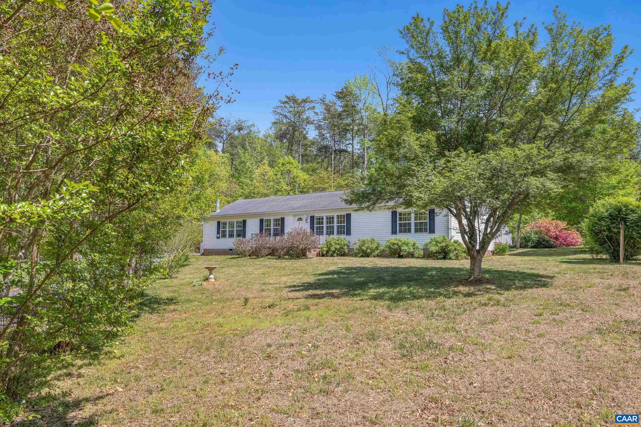 Set on nearly 10 acres, this beautifully maintained home offers over 1,900 square feet of comfortable, single-level living with 3 bedrooms and 2.5 bathrooms. Tucked back from the road, the property blends open grassy areas?ideal for gardening?and wooded privacy with trails perfect for private walks. Inside, you?ll find a spacious, open layout filled with natural light. The large kitchen features stainless steel appliances, an oversized island, and generous counter/cabinet space, flowing seamlessly into the cozy family room and eat-in area with a cozy fireplace. Formal living and dining rooms provide additional space for entertaining. The generously sized bedrooms include a primary suite with a walk-in closet, double vanity, water closet, and a soaking tub designed for relaxation. And large laundry room too. A bright sunroom with walls of windows overlooks the backyard, and two expansive decks offer great outdoor living space. Additional storage is available in the carport and sheds.Ideally located and full of charm, this property is a must-see!,Painted Cabinets,Wood Cabinets,Fireplace in Family Room