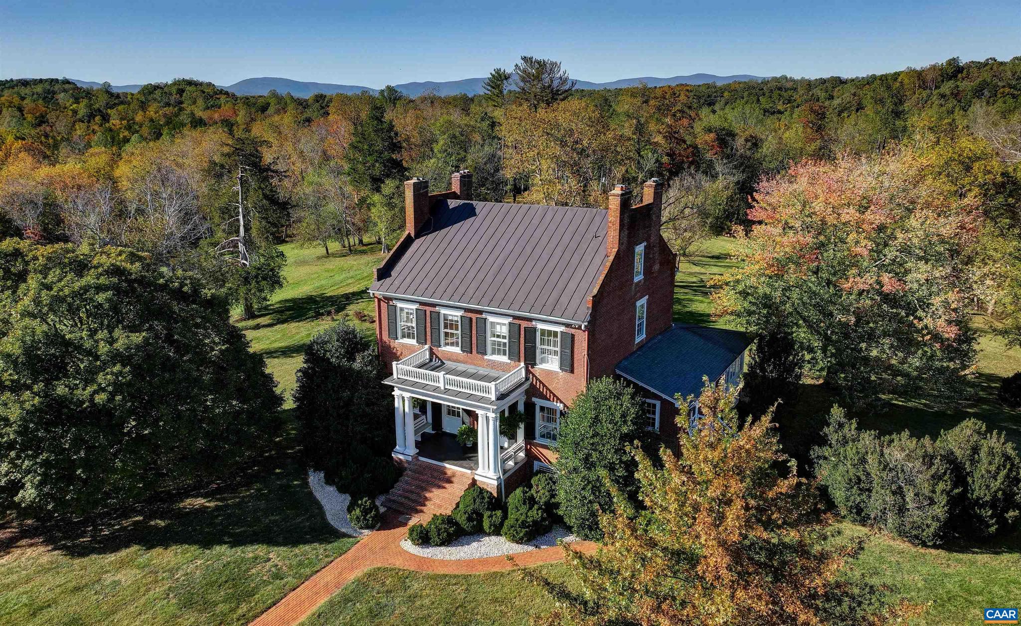 Bel Aire ? Elegant and timeless, this stately 1810 Federal-style residence on 100+/- acres blends historic detail & craftsmanship w/ contemporary livability. The gracious foyer opens to beautifully proportioned formal rooms ? living & dining rooms, complemented by an updated gourmet kitchen flowing seamlessly into a light-filled family room & screen porch overlooking the grounds, creating an inviting space for gathering & entertaining. The first floor guest suite with bath provides privacy & convenience. Upstairs includes a spacious primary bedroom, serene marble bath, additional bedroom & a handsome library. Third floor w/ bedroom, full bath, office or studio space offers abundant versatility.  The English basement  provides flexible space ideal for game/family room, fitness room, laundry with storage, plus a climate-controlled wine cellar. Throughout the incredible architectural details include heart pine floors, 12-foot ceilings, 8 fireplaces with hand-carved mantles, chair rails & paneled wainscoting.  Outdoors enjoy firepit area, stone barn & grounds of open hayfields & woodlands w/ five miles of private walking trails & 3/4 mile Rivanna River frontage. Conservation easement candidate. Convenient to amenities & Univ of VA.,Soapstone Counter,White Cabinets,Fireplace in Basement,Fireplace in Bedroom,Fireplace in Dining Room,Fireplace in Foyer,Fireplace in Living Room,Fireplace in Master Bedroom,Fireplace in Study/Library