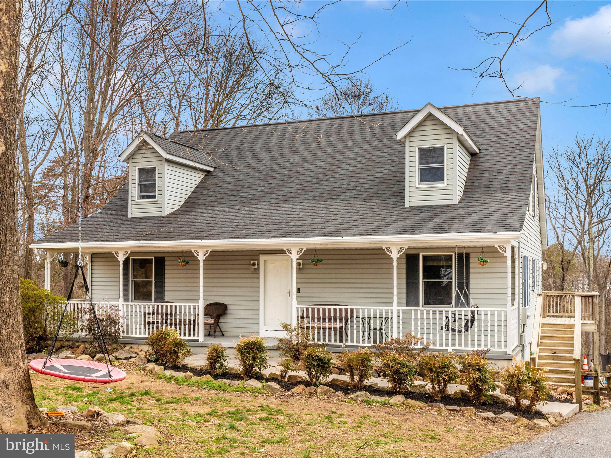 Welcome to 215 Regal Drive in Falling Waters, WV. This beautiful four-bedroom, three-and-a-half-bath Cape Cod is nestled on a 2.08-acre lot in the desirable Kingsbrooke on the Potomac community, coming with A RIVER lot lease that transfers for the new owner. Just in time for river season!

The main level features a spacious owner’s suite with a private bathroom, as well as an open living room and kitchen floor plan, creating a warm and inviting space perfect for entertaining. A conveniently located laundry room adds to the home's practicality. Upstairs, three additional bedrooms and a full bathroom offer plenty of space for family or guests.

The finished walk-out basement includes a bonus room, workout room, a full bathroom, and extra storage space. Additional attic storage ensures ample room for belongings. A rear-entry attached garage provides convenience and a clean aesthetic. Outside, beautiful landscaping enhances the curb appeal, while the large backyard and lovely patio area offer the perfect space to relax and enjoy the peaceful surroundings.

A small balcony on the back of the home offers the potential for a cozy outdoor retreat, with the existing board and structure, it has the potential for making for a full-sized deck.

This home is equipped with a central vacuum system, adding to its convenience and ease of maintenance.

This home offers a wonderful combination of privacy and convenience, with easy access to major highways, shopping, and dining. Don’t miss this opportunity to own a beautiful home in a sought-after community. Schedule your private tour today.