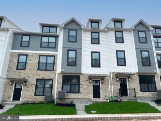 MOVE-IN READY! Welcome to The Fields at Jacobs Way, where luxury, convenience, and low-maintenance living come together. This beautifully appointed Pennington I townhome offers 1,883 sq. ft. of thoughtfully designed living space featuring 3 bedrooms, 2 full baths, 2 half baths, and a finished lower level. The striking modern stone exterior with bay window creates exceptional curb appeal, while the 11' x 6' Trex deck provides the perfect outdoor space for relaxing or entertaining. The open-concept main level showcases a spacious family room, designer kitchen, and dining area ideal for everyday living and hosting guests. The finished lower level with half bath offers flexible space for a home office, fitness area, or recreation room. Upstairs, the owner's suite features a private bath and generous walk-in closet, complemented by two additional bedrooms and a full hall bath. Conveniently located just minutes from the PA Turnpike and major commuter routes, this home offers easy access to both the Lehigh Valley and Philadelphia, making it ideal for commuters seeking the perfect balance of suburban living and accessibility. Don't wait to build—move in now and start enjoying your new home today!