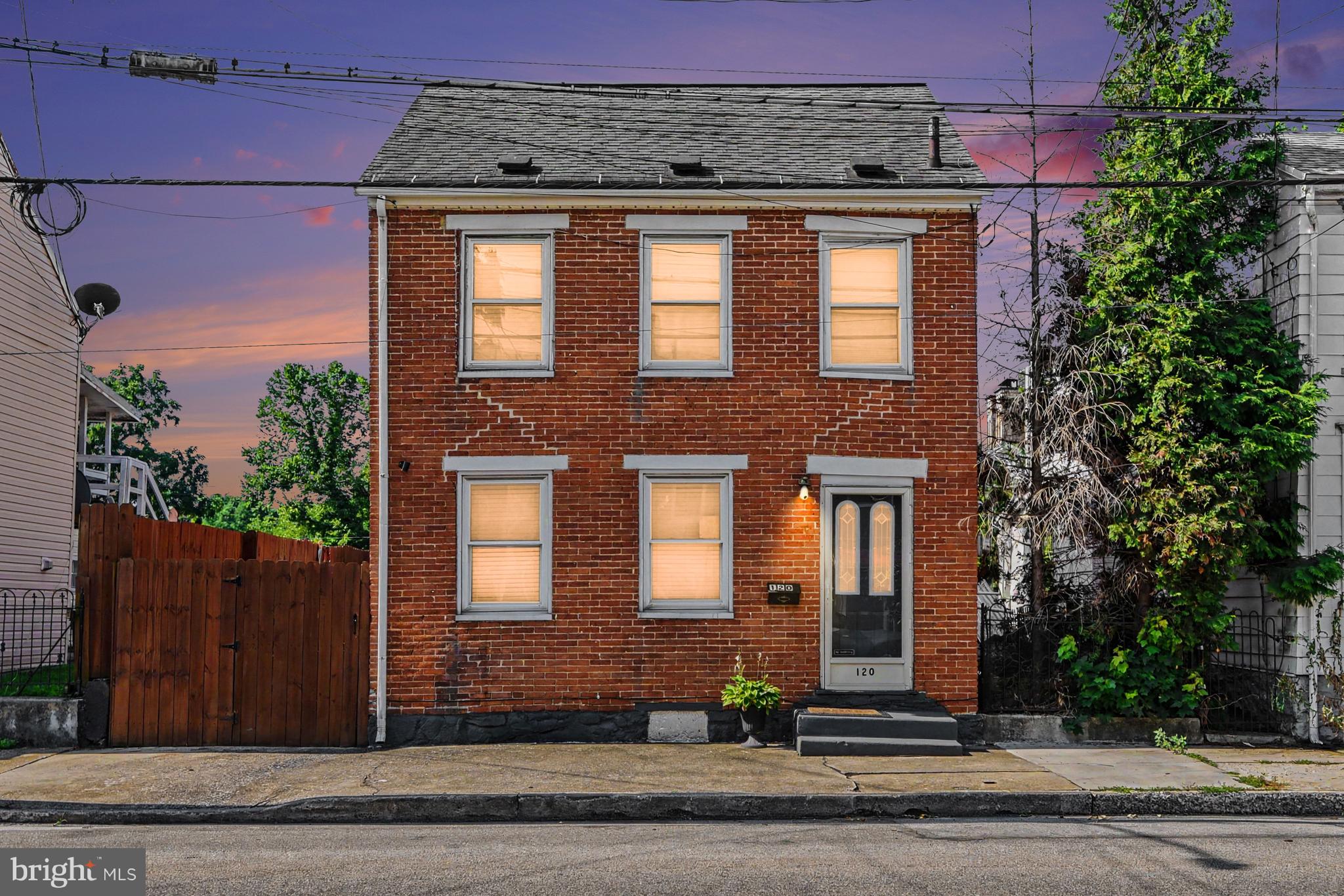 Historic character, inviting living spaces, and an outdoor setting designed for gathering come together in this detached brick home built in 1890. With three bedrooms and a thoughtfully designed backyard, this home offers a wonderful blend of charm and everyday comfort.

The main level offers a comfortable flow from the living room to the dining area and into the kitchen, creating a layout that's well suited for both everyday living and entertaining. The kitchen features a center island with a built-in mini refrigerator, generous workspace, and includes the oven/range, dishwasher, refrigerator, washer, and dryer.

Upstairs, you'll find three bedrooms and a full bath. The walk-up attic provides excellent storage and offers future potential for additional finished living space, whether you envision a home office, hobby room, or an additional bedroom.

Step outside to enjoy one of the home's standout features, a fully fenced backyard designed with outdoor living in mind. Multiple gathering spaces include a composite deck, stone porch, pergola, paved patio, and a covered grilling area, making it easy to entertain or simply relax outdoors throughout the seasons.

Ideally located just a short walk from downtown Carlisle's shops, restaurants, coffee houses, parks, and year-round events, this home also offers convenient access to Dickinson College, the Carlisle Barracks, Interstate 81, and the Pennsylvania Turnpike