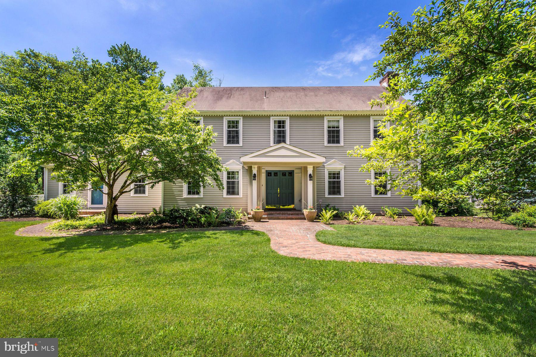 A rare opportunity in Doylestown!  Set in a nature lover's sanctuary, 4444 Bergstrom Road is a historical reproduction of a Deerfield, Massachusetts clapboard home, custom built with attention to detail set on 2.95 acres. Entering the home through a charming, covered portico, a spacious office and living room with fireplace flank the foyer.  There is a wonderful great room/dining area with solid wood beams lining the ceiling.  There is also an expansive wood burning fireplace and windows providing natural light and beautiful views of the grounds.  An attached 1st floor suite includes a full kitchen, living room, bedroom and bath.  The apartment also has a separate entrance offering ideal living arrangements for in-laws, guests or an au-paire. The second floor offers a primary suite with en-suite bath, a large walk-in closet with a laundry chute.  There are an additional 3 bedrooms and a full bath.
A spacious finished basement provides extensive storage and the opportunity for additional living space.
Surrounded by a wooded backdrop, the rear yard is fully fenced and offers a potting shed, patios and a beautiful pool area with new tile and coping.  Cattails wave in a contained wetland area providing bird habitat, and a charming stream with small wooden footbridge meanders across the property. Adjacent to the circular driveway is a separate 3 car garage with plenty of space for a hobby/storage area.  The property is sited on one of the areas prettiest roads lined with mature trees and across from 33 acres of protected township woods.  Located in the Central Bucks School District, the property is just minutes from Doylestown offering a multitude of shops, restaurants, museums and cultural venues.  The borough offers a blend of small-town charm with amenities including commuter rail service to Philadelphia.