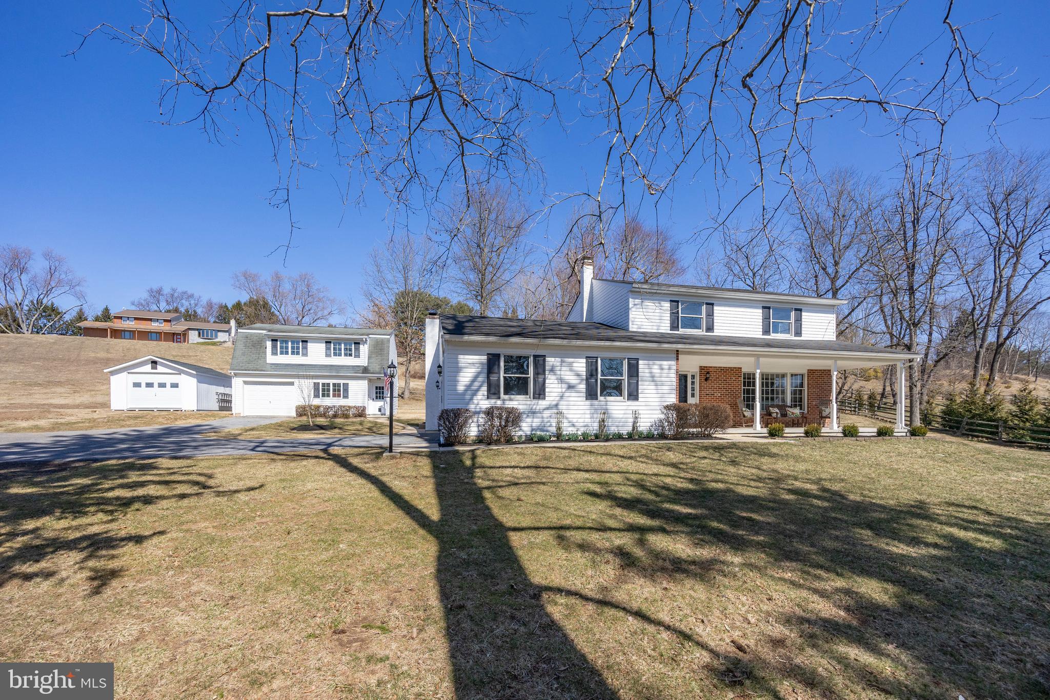 Set on a private 1-acre lot, this beautifully updated 4-bedroom, 2.5-bath home with attached 2 car garage in West Chester offers 2242 sf of living space, modern upgrades, low taxes, and incredible versatility. A 28’ x 24’ outbuilding with high ceilings serves as a spacious workshop, perfect for woodworking, furniture refinishing, or recreational and work vehicle storage, while a separate entrance with staircase leads to a finished room above, ideal for a home office, art studio, or gym. A newer shed provides extra storage, and an extended driveway accommodates 5+ vehicles. A spacious covered front porch welcomes you into the freshly painted interior, where new wood floors extend throughout most of the first level. The comfortable floor plan includes a living room with built-in shelving and a bay window, a dining room for entertaining, and an eat-in kitchen featuring KraftMaid cherry cabinetry, new stainless-steel appliances, granite countertops, and a tile backsplash. The cozy family room boasts a brick fireplace and ceiling fan, while the 20 x 16 sunroom, with new LVP flooring and a wall of windows overlooking the private backyard, offers the perfect flex space for a playroom, office, home gym or entertaining guests. A laundry room and remodeled powder room complete the first floor. Upstairs, the primary bedroom includes a brand-new bathroom, while three additional bedrooms share a fully renovated hall bath. The basement, featuring two egress windows and studded walls, is ready to be finished for additional living space. Recent updates include a new heating and air conditioning system – efficient heat pump with oil back-up heating system  (2024), siding, gutters and garage door (2022), three renovated bathrooms (2024), garage door on the outbuilding (2025), new well pump and well cap (2024) and well pressure tank (2023), wood flooring (2025), carpeting on the second floor (2025), LVP flooring in the sunroom (2025), ductwork cleaning (2024), chimney liner, crown and stucco redone (2018), and updated lighting and hardware throughout. Located in the award-winning West Chester School District (Rustin HS, Stetson MS, and Westtown-Thornbury Elementary) with convenient access to Routes 202, 3, and 100, this exceptional property is just minutes from the fantastic dining and shoppes of West Chester Borough. Don’t miss this special opportunity—schedule your showing today!