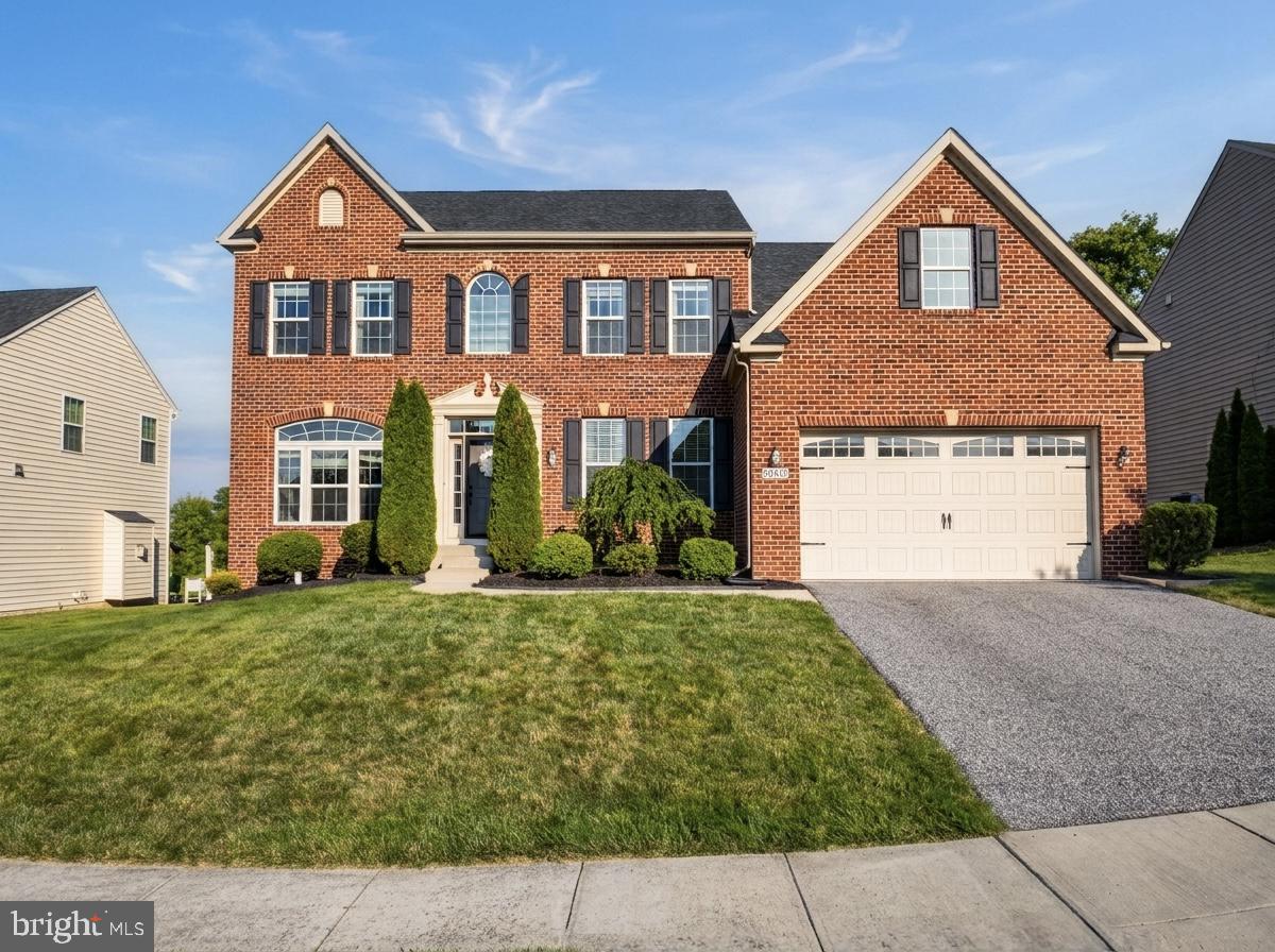 Welcome to this stunning brick-front Colonial in the sought-after Windlass Overlook community, offering over 5,000 square feet of beautifully finished living space where timeless elegance meets modern comfort. From the moment you arrive, the gorgeous curb appeal, manicured lawn, oversized two-car garage, and private lot backing to trees set the tone for what awaits inside.

Step into the dramatic two-story foyer featuring a grand staircase with rich hardwood flooring, decorative columns, extensive crown molding, and elegant trim work throughout. The thoughtfully designed main level offers formal living and dining rooms with tray ceilings, a private home office, an extended family room highlighted by a floor-to-ceiling stone fireplace, built-in Klipsch 5.1 surround sound and a bright morning room extension. At the heart of the home, the gourmet kitchen features granite countertops, an extended tile backsplash, stainless steel appliances, abundant cabinetry, and a large center island—perfect for everyday living and entertaining.

Upstairs, the luxurious primary suite offers a spacious sitting area, walk-in closet, and a spa-inspired bath with a soaking tub, oversized shower, and dual vanities. A private guest suite with its own full bath provides ideal accommodations for visitors, while two additional bedrooms are connected by a convenient Jack-and-Jill bath. The upgraded laundry room includes a utility sink for added convenience.

The finished lower level is designed for entertaining with an expansive recreation room, a custom wet bar featuring granite countertops and oversized island seating, flexible bonus space, and a full bath.

Step outside to the spacious Trex deck overlooking the private backyard, perfect for relaxing or entertaining. Additional features include upgraded hardwood flooring throughout the main level, recessed lighting, neutral designer paint, abundant storage, and quality finishes throughout. This exceptional home offers luxurious finishes, thoughtful design, and versatile living spaces in one truly remarkable property.