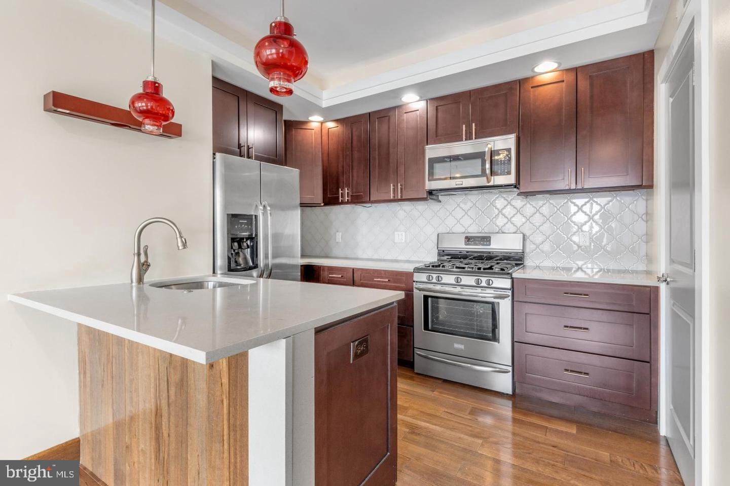 Welcome to 1241 Buttonwood St #4C! Experience modern city living in this bright and inviting 4th-floor condo featuring 2 bedrooms and 2 bathrooms. Highlights include a private garage parking space, elevator access, a personal rooftop deck, in-unit laundry, and beautiful hardwood flooring throughout.
Step inside to a well-appointed kitchen with plenty of cabinet space, a sleek tile backsplash, counter seating, and a full suite of stainless steel appliances. The kitchen flows effortlessly into a spacious living and dining area, filled with natural light and complemented by a convenient storage closet. Just off the hallway, you’ll find a full bathroom with a vanity and glass-enclosed shower, along with a tucked-away laundry area for added convenience.
The home offers a generously sized secondary bedroom with ample closet space, as well as a larger primary suite complete with dual closets and a private en-suite bathroom featuring a shower/tub combination. Upstairs, enjoy access to an expansive rooftop deck—perfect for relaxing or entertaining while taking in sweeping city views.
Situated in the vibrant Callowhill neighborhood, this area combines industrial character with contemporary energy. Residents enjoy nearby green space at the Rail Park, easy commuting via SEPTA’s Broad Street Line and multiple bus routes, and a dynamic mix of local cafes, restaurants, galleries, and fitness studios.