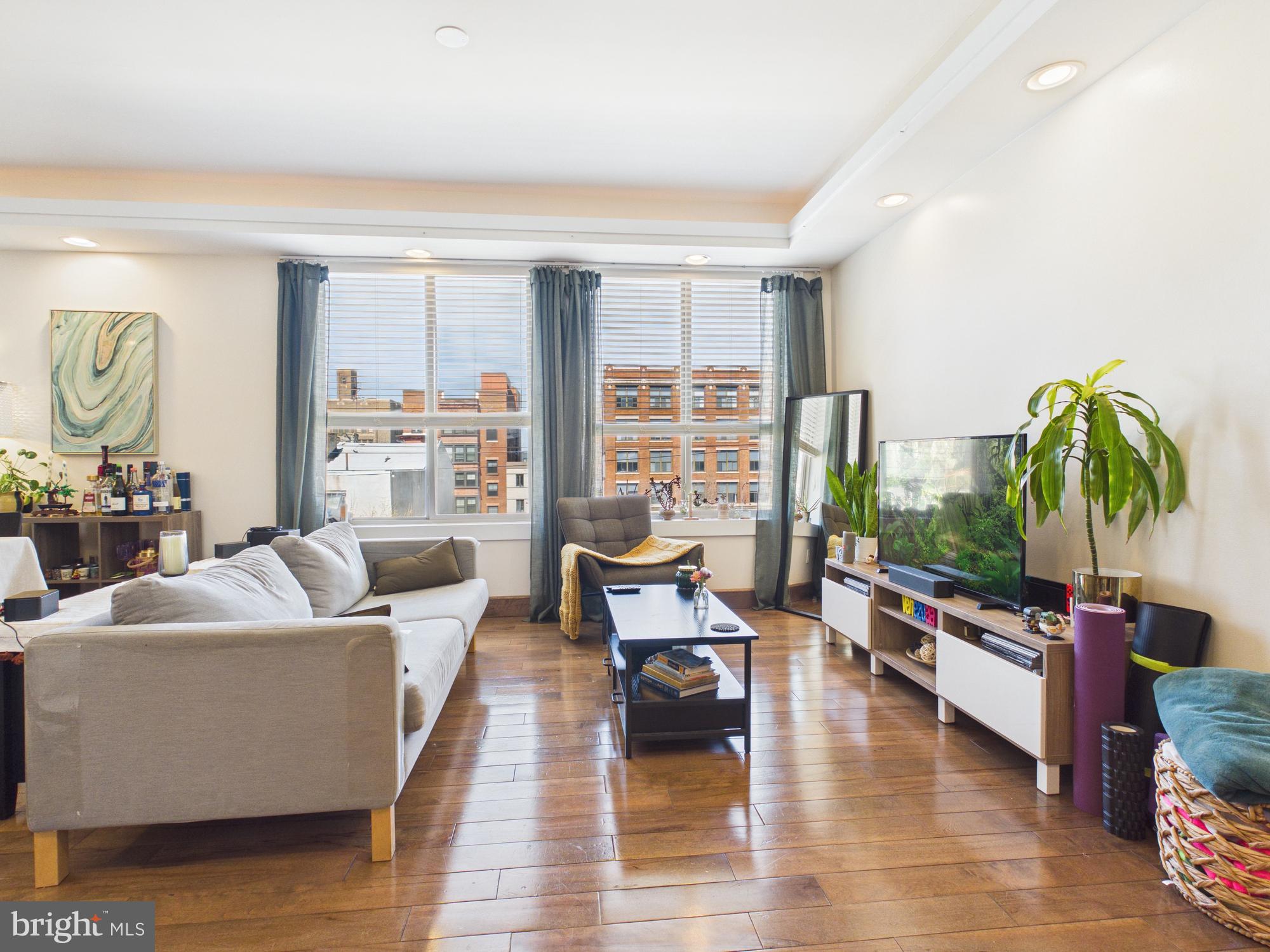 Welcome to 1241 Buttonwood St #4C! Experience modern city living in this bright and inviting 4th-floor condo featuring 2 bedrooms and 2 bathrooms. Highlights include a private garage parking space, elevator access, a personal rooftop deck, in-unit laundry, and beautiful hardwood flooring throughout.
Step inside to a well-appointed kitchen with plenty of cabinet space, a sleek tile backsplash, counter seating, and a full suite of stainless steel appliances. The kitchen flows effortlessly into a spacious living and dining area, filled with natural light and complemented by a convenient storage closet. Just off the hallway, you’ll find a full bathroom with a vanity and glass-enclosed shower, along with a tucked-away laundry area for added convenience.
The home offers a generously sized secondary bedroom with ample closet space, as well as a larger primary suite complete with dual closets and a private en-suite bathroom featuring a shower/tub combination. Upstairs, enjoy access to an expansive rooftop deck—perfect for relaxing or entertaining while taking in sweeping city views.
Situated in the vibrant Callowhill neighborhood, this area combines industrial character with contemporary energy. Residents enjoy nearby green space at the Rail Park, easy commuting via SEPTA’s Broad Street Line and multiple bus routes, and a dynamic mix of local cafes, restaurants, galleries, and fitness studios.