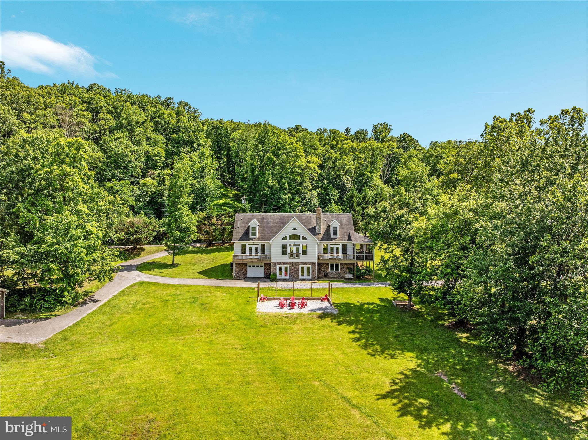 Rare Riverfront Retreat on 18+ Acres with Private Shenandoah River Access – Ideal Turnkey Airbnb Investment, Primary Home, or Weekend Escape!!! Unlock the potential of this remarkable four-bedroom, four-bathroom estate nestled on over 18 sprawling acres, featuring exclusive private access to the beautiful Shenandoah River. This exceptional property offers a rare blend of luxury living and abundant space. Currently operating as a successful Airbnb, this home is fully equipped and ready for continued short-term rentals—making it a true turnkey investment. Whether you’re looking to maintain the established rental income, create a serene primary residence, or design the perfect weekend retreat, this riverfront sanctuary effortlessly adapts to your lifestyle needs. Inside, the huge family room boasts soaring cathedral ceilings and tons of natural light, creating a warm and welcoming atmosphere. All four bedrooms are generously sized, offering comfort and versatility for family and guests alike. The primary bedroom, complete with an en-suite and private balcony, is located on the main level, as well as a second bedroom situated next to a full bath. A front ramp ensures no stairs are required to access the main level of the home! There are also several bonus spaces upstairs and down for ultimate flexibility; one is often used as an extra bedroom for Airbnb guests. The large screened-in porch provides an inviting space to enjoy a cup of coffee or entertain guests year-round. Step outside to enjoy not one, but two charming fire pit areas—one conveniently located by the home for cozy evenings, and another nestled by the water’s edge, perfect for memorable nights under the stars. Additional features include a large detached two-car garage with ample storage, perfect for the lawn mower and golf cart, which convey with the property for your convenience and enjoyment. Imagine the possibilities - all located just 15 minutes from downtown Charles Town, WV!! Opportunities like this don’t come often—whether you want a turnkey income property, a luxurious full-time home, or a peaceful weekend sanctuary, this private riverside estate delivers it all. Schedule your showing today!