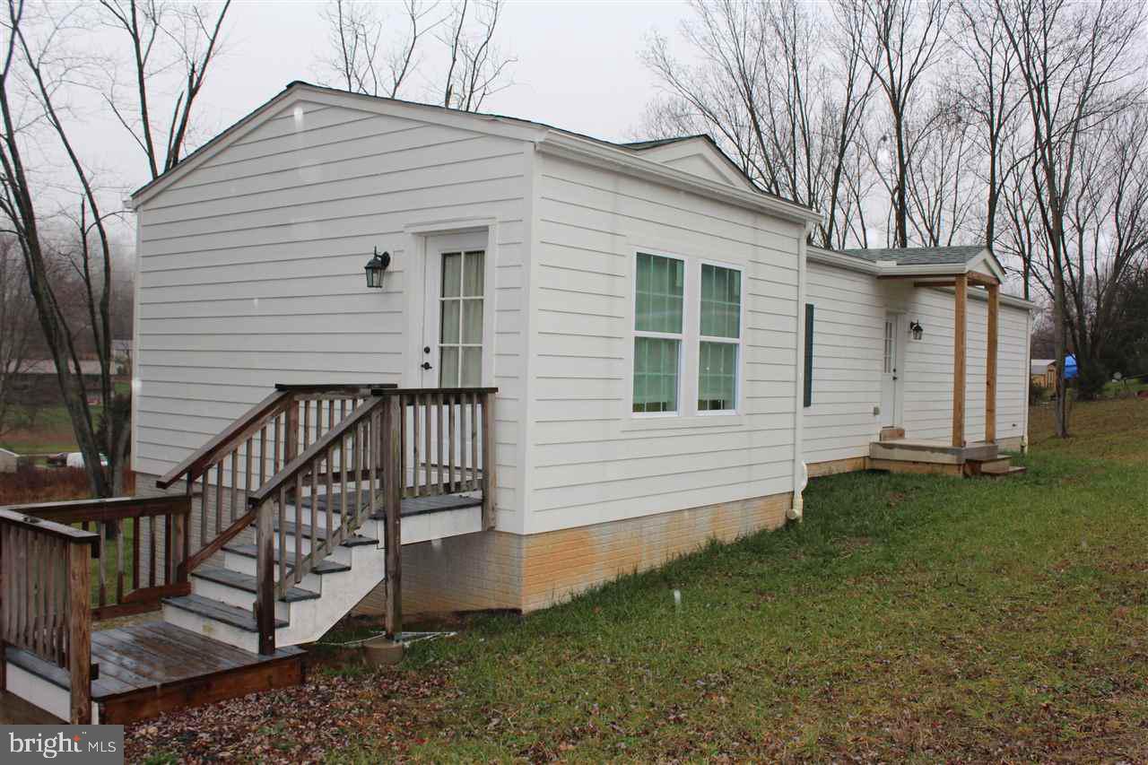 2BR/1BA, modular rancher w/stick-built LR. Full unfinished, walkout basement w/ den, full bath & a 3rd BR already roughed in. Seller will finish at additional cost to Buyer. 6" thick walls filled w/styrofoam insulation. Cement board exterior. 0.6887 acre lot. Minutes to MD/PA. line. Assessed value based on lot only.