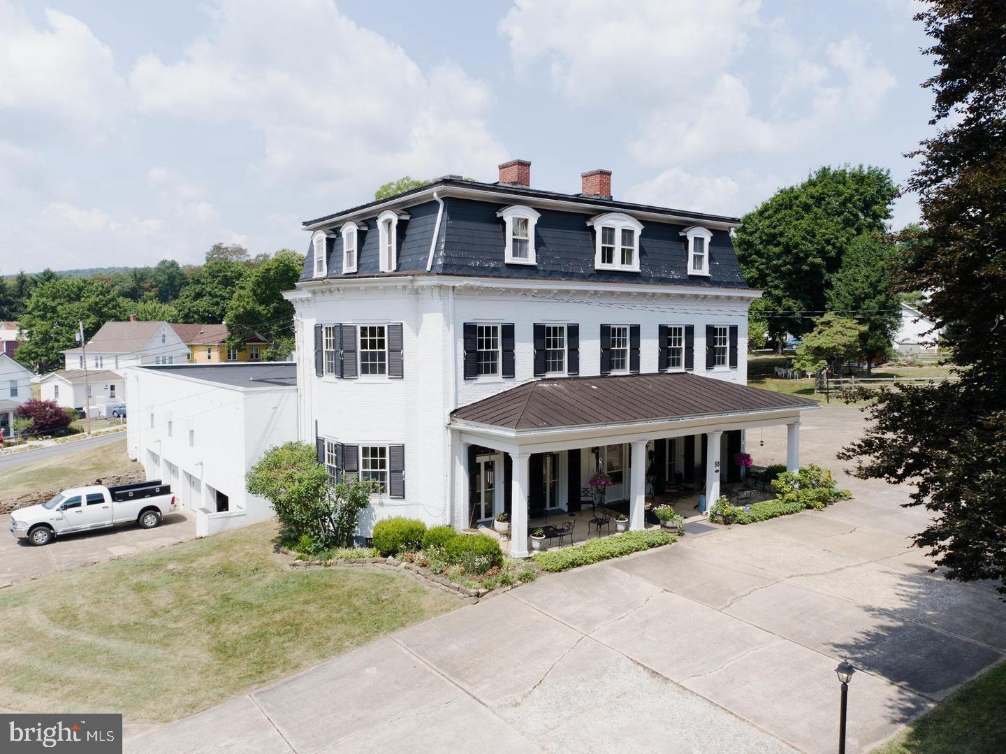 Large Historic Residence built in 1848 by the Founding Father of Frostburg. 5,700 sf +/- with up to 6 B&B Rooms (Zoning approval required) PLUS massive 8,000 SF +/- modern commercial grade addition built with structural steel and masonry. Could be used as a single family residence with a huge basement garage and a massive main level addition that could be used for home occupation, additional garages, or conversion for additional units (with BZA Approval) Lots of recent work to shore up the exterior details, beautiful site that is level to mildly sloped and plans to divide another building lot off of the rear corner. Surrounded by Frostburg's nicest historic Victorian Era Homes on quiet tree-lined streets.