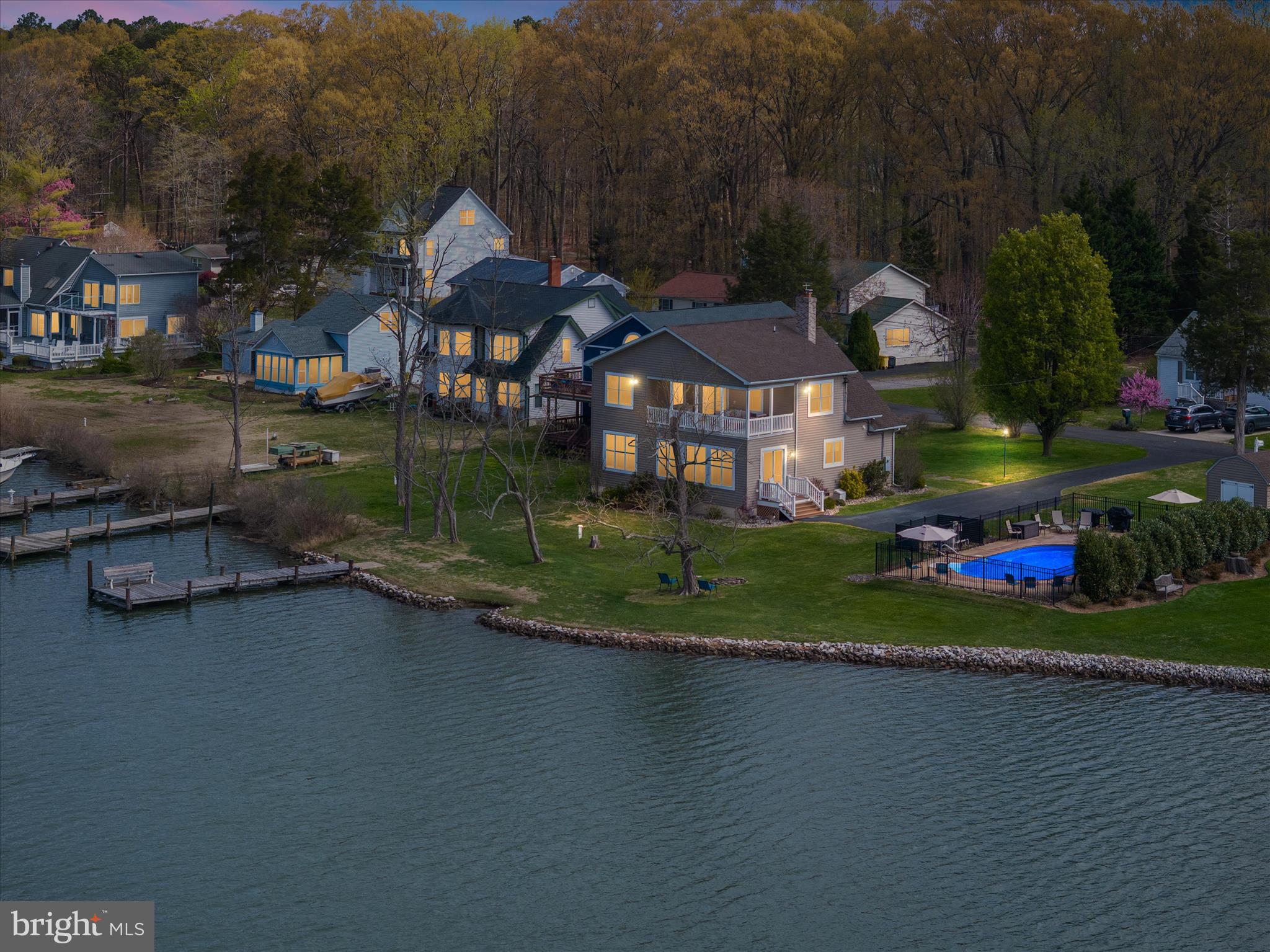 Experience waterfront living the moment you arrive—where the driveway ends and the water begins.
Pull in and you’re immediately greeted by sweeping water views—this is what peaceful waterfront feels like. Tucked away on a quiet dead-end road in Deale, this property offers a rare combination of privacy, space, and direct access to the Chesapeake Bay lifestyle. If you want your future to revolve around the water, this setup simply makes sense. Launch your kayak, paddleboard, jet ski, or small boat right from a ramp on your property, or tie up at your private pier after a day on the bay. Water depth averages 2-3 ft depth. Enjoy fishing, crabbing, or just unwinding as you take in the peaceful surroundings and abundant wildlife. With 125 feet of rip-rap shoreline, you get both beauty and shoreline protection.One of the standout features is the in-ground pool just steps from the water’s edge—a rare find so close to the water - that elevates outdoor living and entertaining.  The liner was replaced in 2024. The home was completely renovated in 2017.  The interior offers an open floor plan, five bedrooms, and three full bathrooms, providing flexibility for everyday living, guests, or multi-generational needs. One of the bedrooms on the main level could be a great home office. A southern-style second-story balcony creates the perfect vantage point to take in elevated water views and coastal breezes. The home’s exterior is finished with low-maintenance materials, making it easy to spend more time enjoying the lifestyle and less time on upkeep. There is a wood burning fireplace and propane back-up heat for extra cold winters. There is also a generator on the side of the house. This unique offering includes two parcels totaling .41 acres—(5936 and 5946 Sneed Dr) the home sits on one lot, while the second lot features the pool and shed, along with additional lot space that opens the door for future possibilities like a garage or expanded outdoor living. A 20.5 bonus right-of-way between the parcels enhances driveway access and usability while allowing additional land space. The two properties fit together seamlessly feels like both are one property.  You have a front yard and a waterside yard. The Sellers are conveying both properties simultaneously and are not interested in selling the pool lot as a separate building site, however Buyers can consider that opportunity upon future ownership. Possible future boat slip if a Buyer wants to pursue a permit for additional pilings at the end of the pier. Flood Insurance  through Allstate is only $839/yr and covers house, pool and shed.  No HOA fees or Special Tax.This is the kind of waterfront opportunity people wait years to find—where every day feels like a getaway, and coming home is the best part. Most waterfront homes require compromise—but this one delivers on space, access, and lifestyle with additional opportunities. Tucked along the western shore of the Chesapeake Bay, Deale offers a rare blend of coastal charm, relaxed living, and true boating lifestyle. Known as a historic fishing village turned hidden gem, this tight-knit community is surrounded by scenic creeks, marinas, and endless water views that define life on the Bay. Residents are drawn to Deale for its laid-back pace and strong sense of community—a place where neighbors know each other, local restaurants welcome you by name, and weekends revolve around farmers markets, waterfront dining, and time on the water.
Despite its peaceful setting, Deale offers convenient access to Annapolis and Washington, D.C., making it an ideal choice for commuters or second-home buyers seeking an easy escape from city life.   **Agents, please reference the documents section and the Agent remarks**