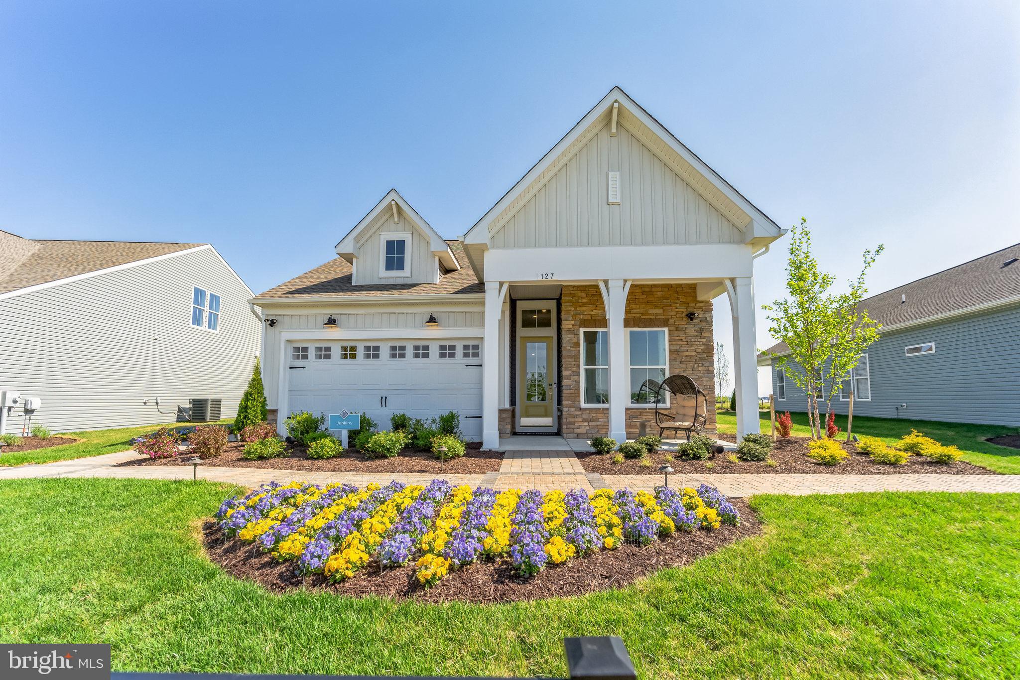 The Jenkins Model Home offers a beautifully crafted open-concept layout paired with high-end designer finishes throughout—now available for immediate settlement with a rent-back opportunity. Thoughtfully designed with 2 bedrooms, 2 baths, and a 2-car garage, this home blends comfort, sophistication, and convenience.

Standout features include a dedicated home office, a cozy fireplace, and a screened patio ideal for indoor–outdoor living. Elevated design moments—such as feature walls, ceiling beams, and barn doors—bring custom flair to each space. As a true bonus, all model home furniture is included, offering a completely move-in-ready experience.

The chef-inspired kitchen showcases a Café range, single oven, microwave, range hood, dishwasher, side-by-side refrigerator, stylish pendant lighting, and a designer tile backsplash. Quartz countertops elevate both the kitchen and the owner’s bath for a cohesive, upscale look.

Hardwood flooring extends across the main level, with tile in all full baths and carpet in Bedroom 2 for added warmth. The owner’s bath features a shower with seat, handheld shower wand, and double sinks, creating a comfortable and functional retreat.

For a full list of included features, please contact our sales representatives.

Welcome to a new luxury active adult 55+ community on Maryland's Chesapeake Bay. Discover the amenity-filled, resort-style experience within 45 miles of Washington DC and Baltimore. Residents can take advantage of the community's 24,000 sq. ft. clubhouse with indoor & outdoor pools, a state-of-the-art fitness center, and multiple tennis and pickleball courts. With a full-time lifestyle director on site the community also features a well-maintained calendar of activities such as walking club, indoor and outdoor yoga sessions, mahjong club, kayaking, pickleball and more. Kent Island life is about making friends and enjoying the company of people who have worked hard and now want to enjoy all that a luxury 55+ community has to offer. Located steps from the water and minutes from Annapolis, the location also offers quick access to Rt. 50. Enjoy the convenience of nearby dining and shopping options together with the quaint charm of a small town.