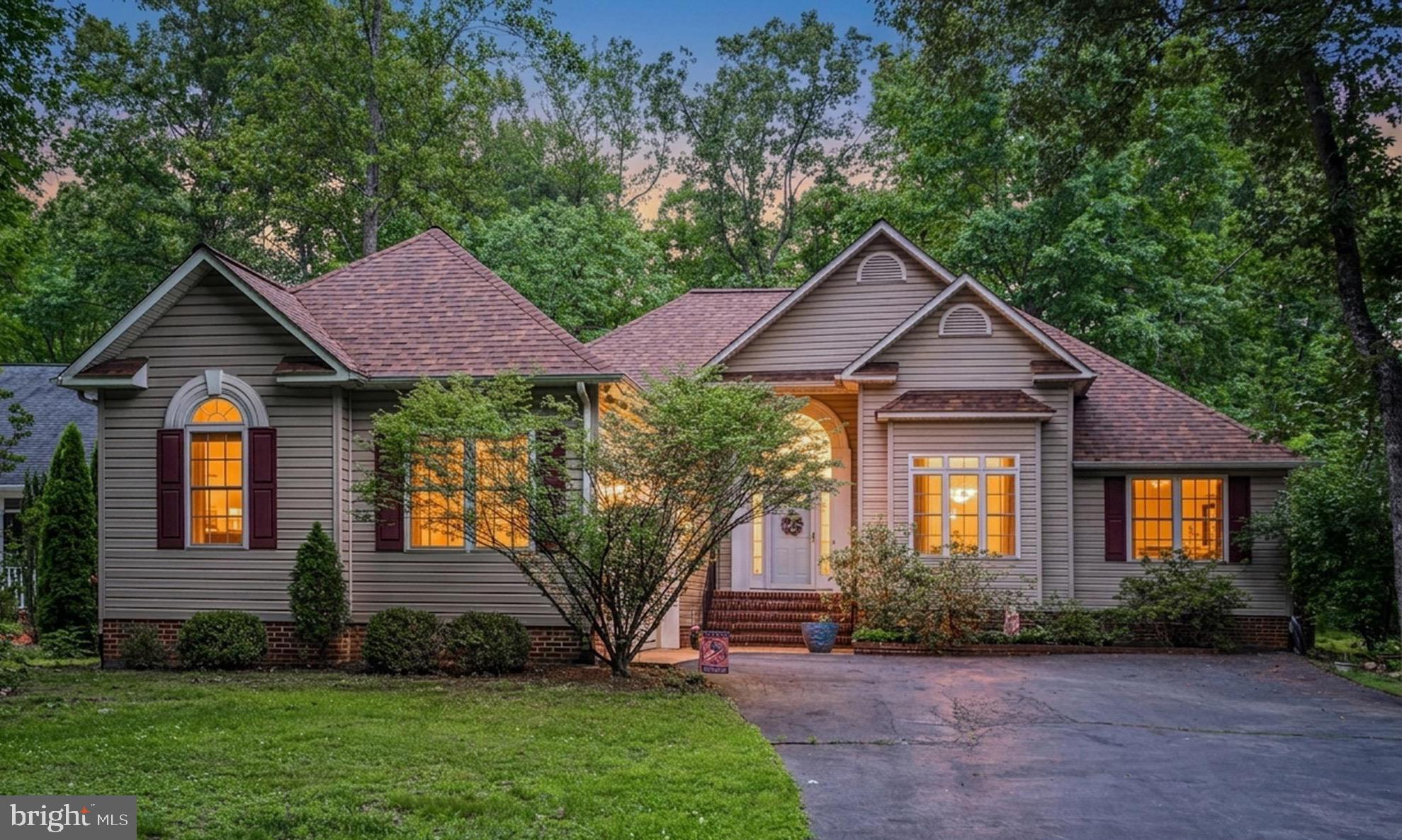 Welcome to 103 Cedar Court! Tucked away on a quiet cul-de-sac and backing to a peaceful tree line, this three-bedroom, two-and-a-half-bath rambler is the kind of home that invites you to slow down, spread out, and enjoy each day. From the moment you step inside, hardwood floors and soaring cathedral ceilings set the tone for the warm, welcoming spaces that await. Sunlight fills the living room, where a corner gas fireplace creates the perfect place to gather on cool evenings or simply relax with a good book.

The oversized dining room offers endless possibilities. Host memorable dinners, create a stylish home office, or design a space that fits your lifestyle. The kitchen is thoughtfully designed with generous counter space, a pantry, room for a breakfast table, and easy access to the screened porch and deck. Whether you're sipping coffee as the birds sing, enjoying dinner outdoors, or entertaining family and friends, these outdoor living spaces become a natural extension of the home.

The split bedroom floor plan provides comfort and privacy. Tucked away on its own side of the home, the primary suite offers a peaceful retreat with a tray ceiling, abundant natural light, a large walk-in closet, and a spa-inspired bath featuring a double vanity, soaking tub, and separate shower. The nearby half bath, laundry area, and oversized garage with room for a workshop make everyday living both easy and practical.

On the opposite side of the home, two additional bedrooms share an updated full bath. A separate sitting room just off the third bedroom adds even more versatility and is ideal for a home office, library, hobby room, fitness space, or a potential fourth bedroom that is not to code.

Surrounded by nature yet designed for everyday living, this home offers the perfect balance of comfort, function, and peaceful living. More than simply a place to live, it's where birthdays are celebrated, conversations linger long after dinner, and the moments that matter most become cherished memories.

Lake of the Woods offers a picturesque lakeside lifestyle with an array of amenities to enjoy. At its heart lies a stunning 550 acre lake, perfect for fishing, water sports, or simply unwinding by the shore. Golf enthusiasts can tee off at the PGA course, while equestrians take advantage of scenic riding trails and a dedicated riding ring. The clubhouse provides the ideal setting to dine on the deck, savoring breathtaking sunsets as boats drift by. Beyond its amenities, this welcoming community thrives on connection, fostering friendships through engaging events and diverse clubs. With gated entrances and security patrols, residents enjoy both tranquility and peace of mind. More than just a place to live, Lake of the Woods is a vibrant retreat where nature and camaraderie come together, creating unforgettable experiences at every turn. Conveniently located in the heart of Locust Grove, this home offers easy access to shopping, dining, wineries, and historical landmarks for those who love history. Plus, with nearby commuter routes, traveling to surrounding areas is effortless. Discover the charm of this exceptional lake community. Call me today to schedule a tour and envision making it your home!